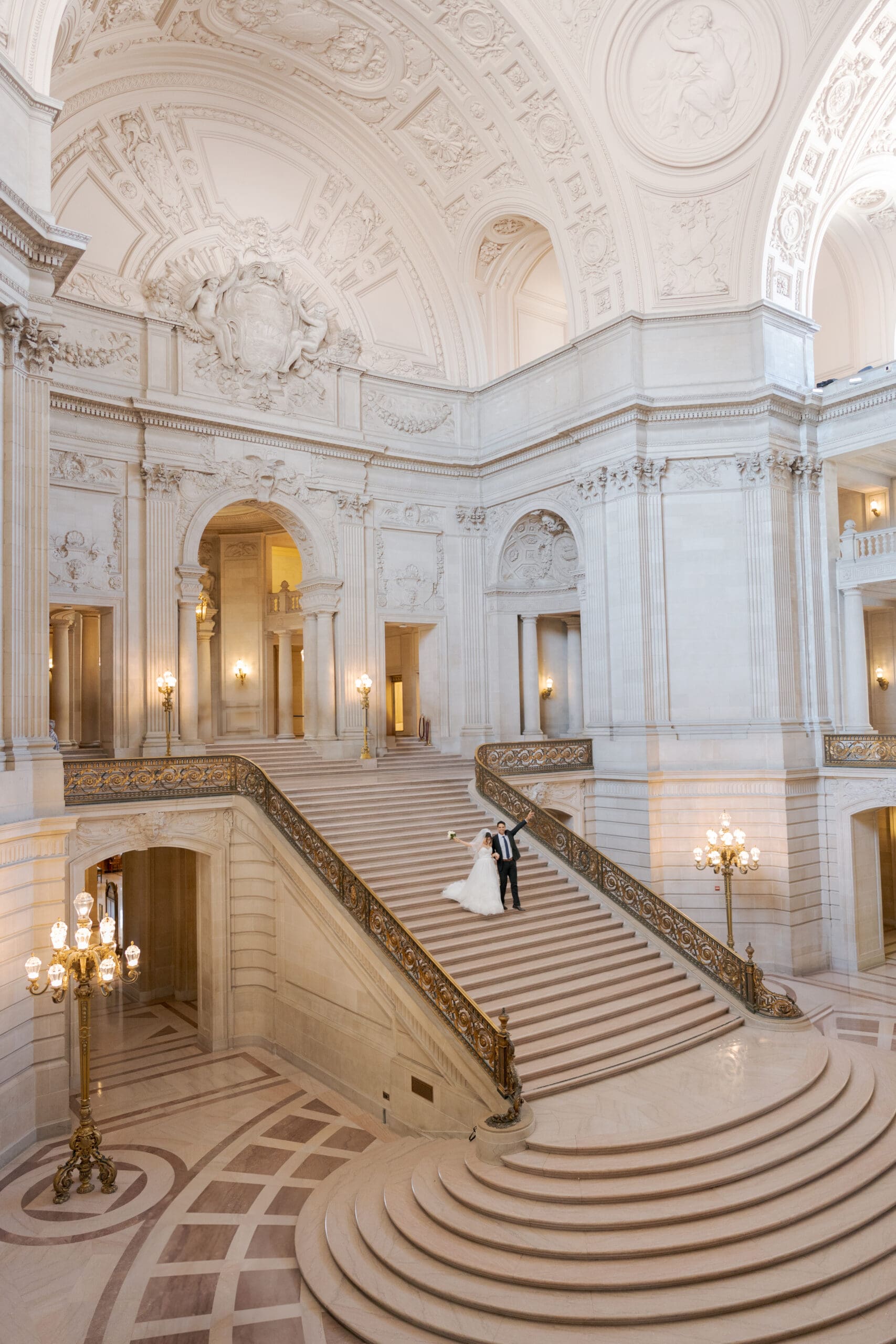 Celebrating couple on the Grand Staircase of City Hall