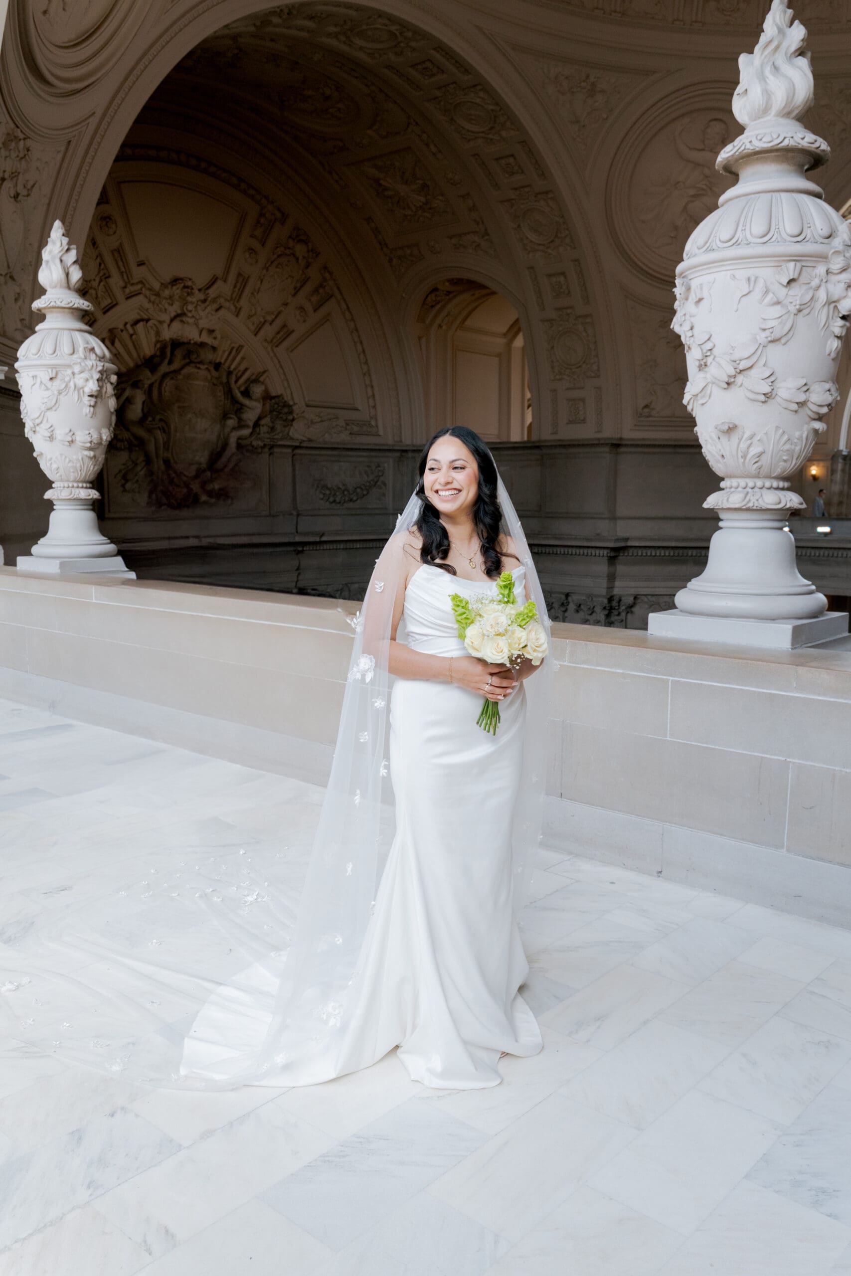 Traditional white dress at San Francisco City Hall with veil and trail