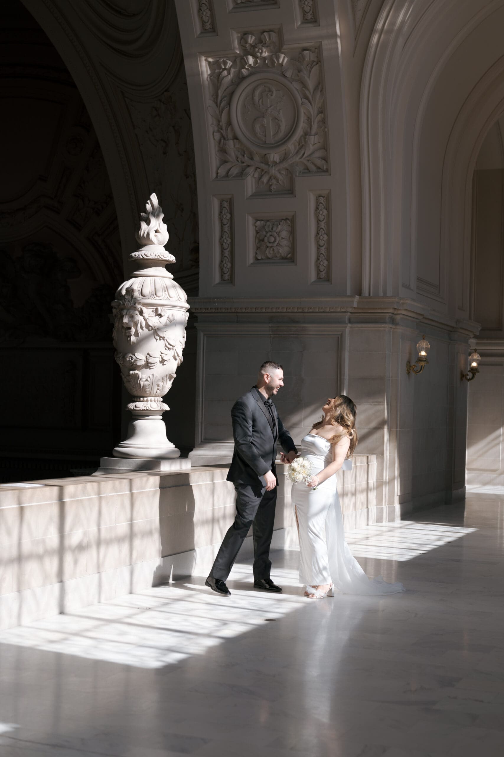 Newlyweds in the natural light of the 4th floor gallery in San Francisco City Hall
