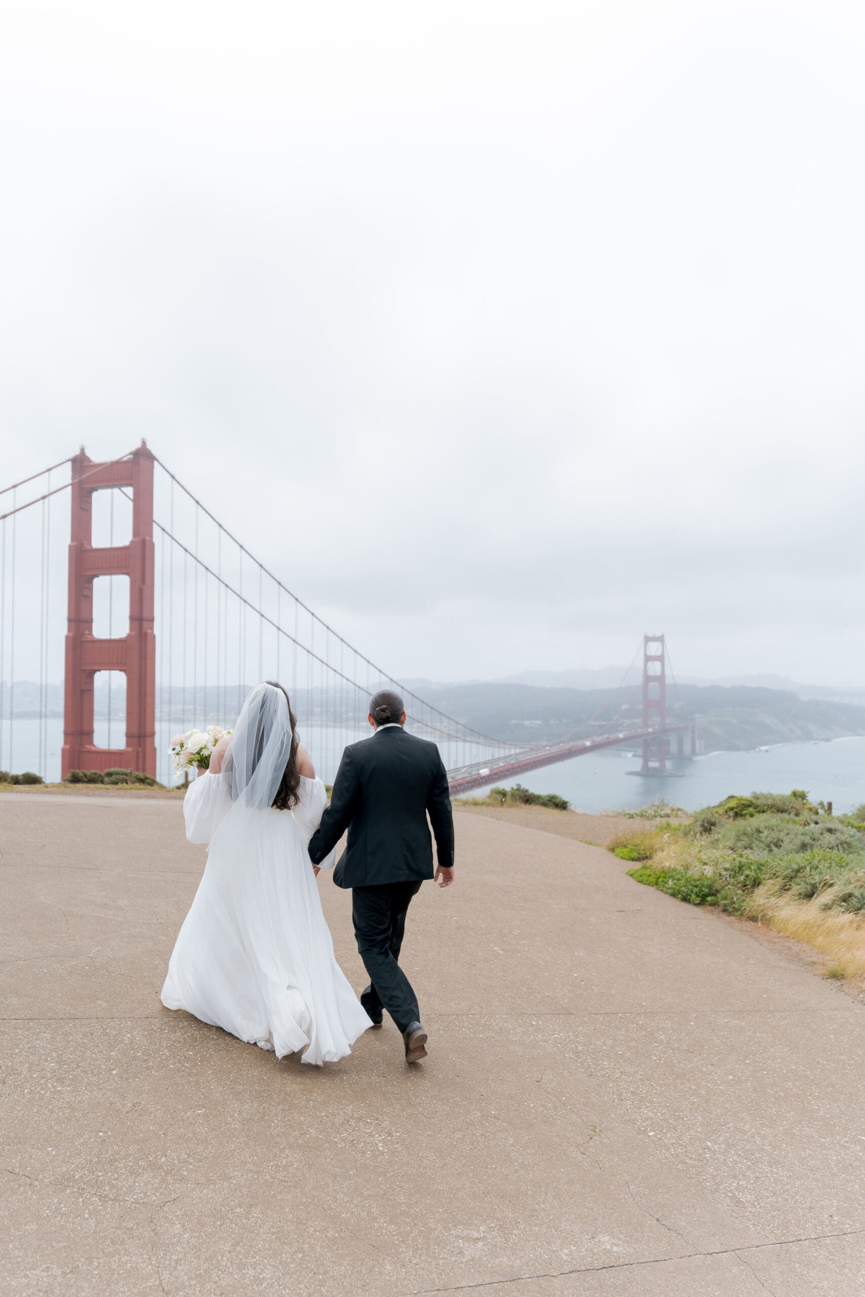 Couple taking in the view of the Golden Gate Bridge after their elopement