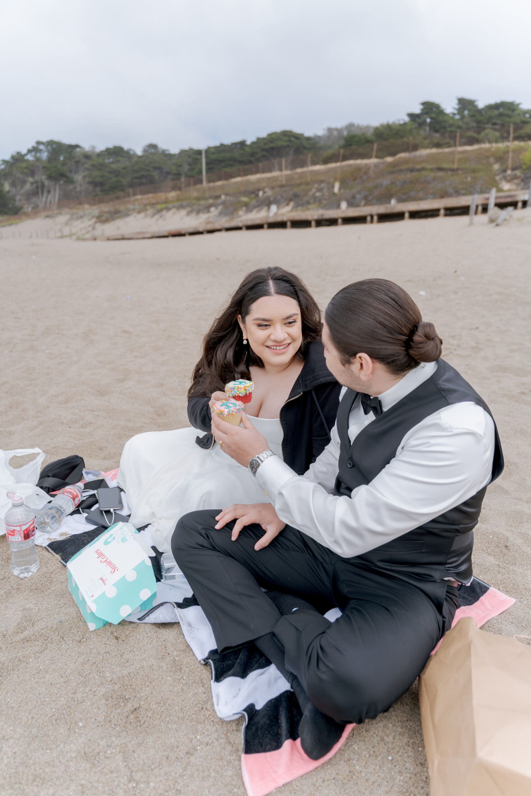 Newlyweds having a picnic on Baker Beach