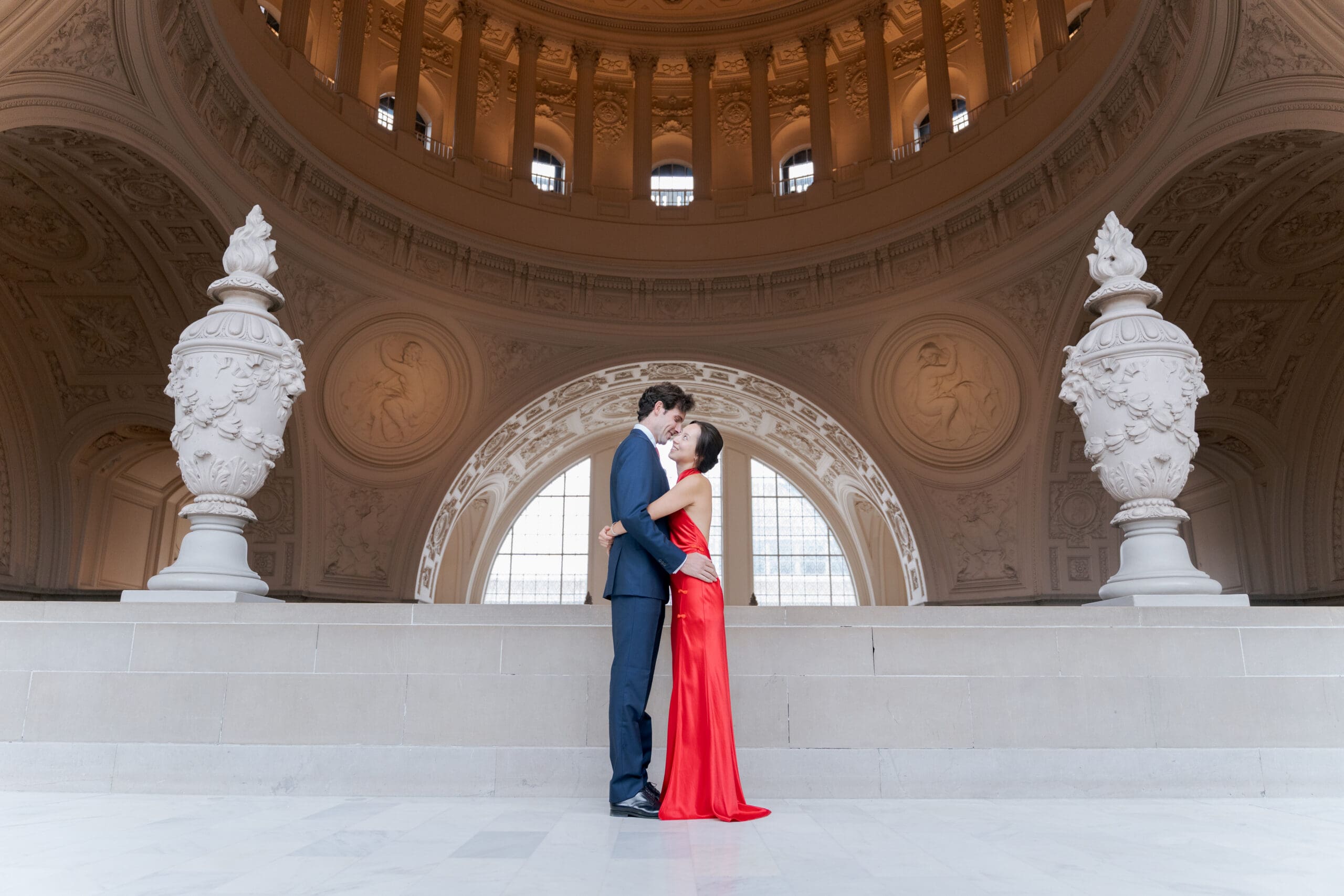 Bride and Groom posing by the architectural arches at San Francisco City Hall.