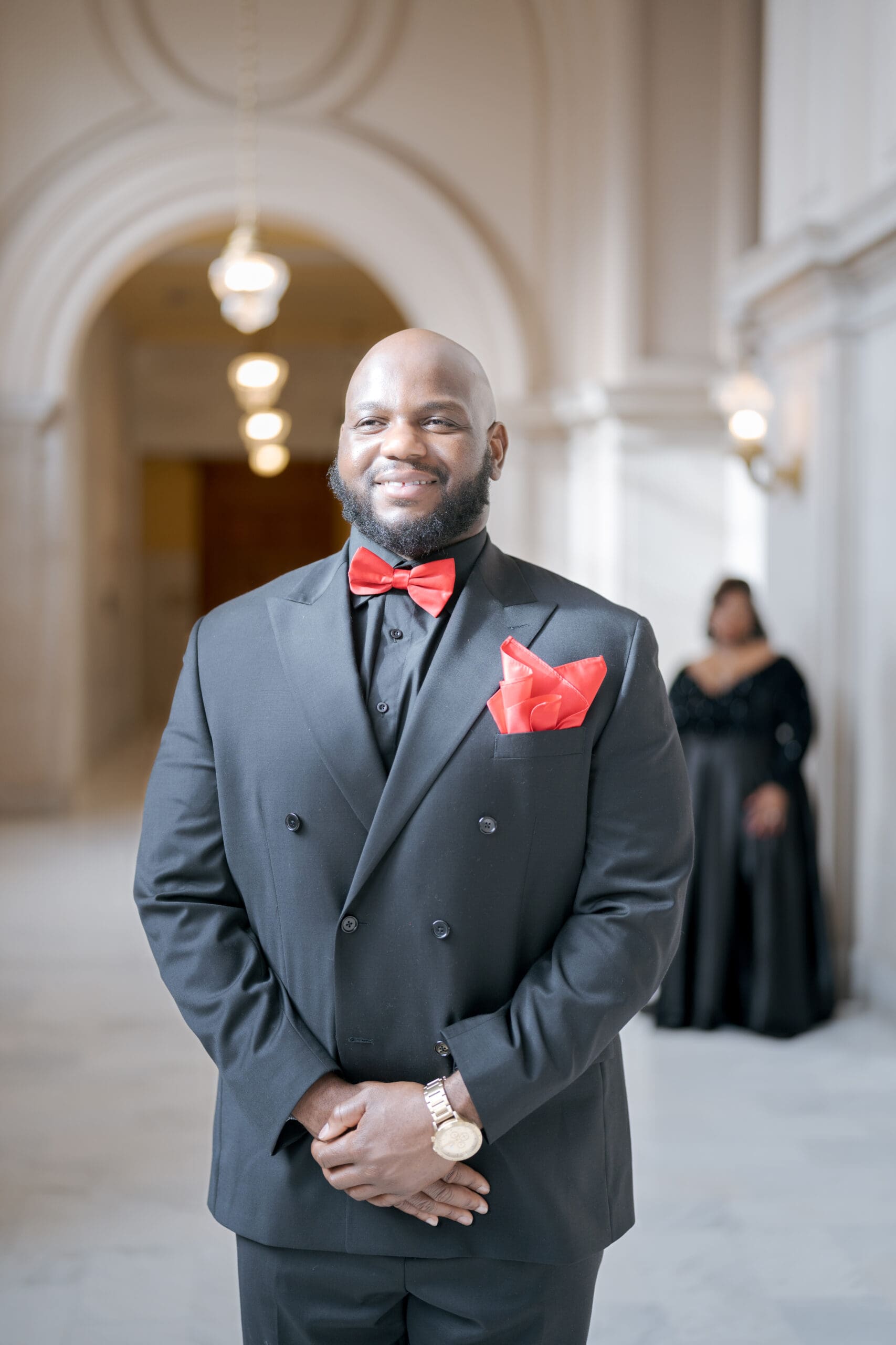 Black and red color accents on groom's suit at San Francisco City Hall