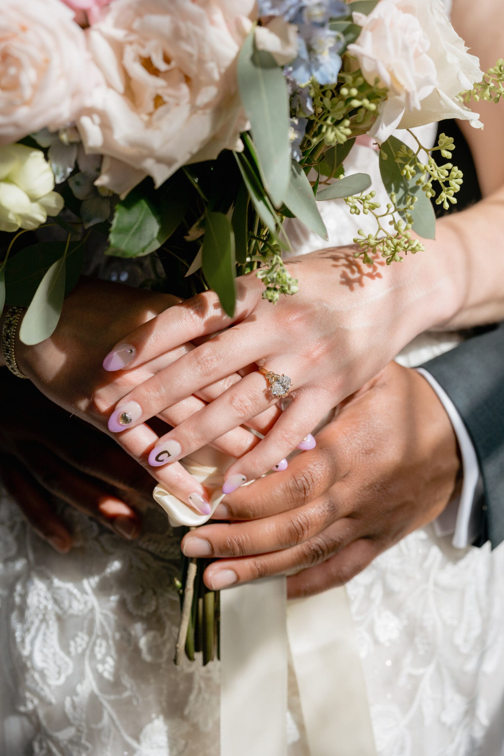 Closeup details of bride and groom's bouquet and rings inside San Francisco City Hall