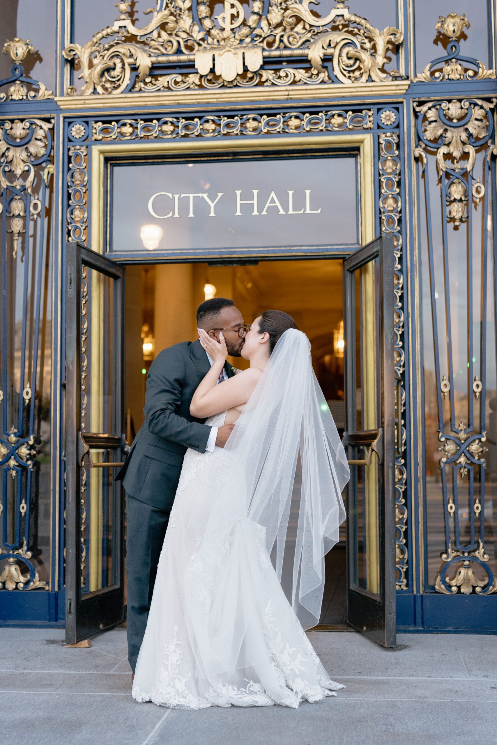 Newlywed couple kiss in front of San Francisco City Hall