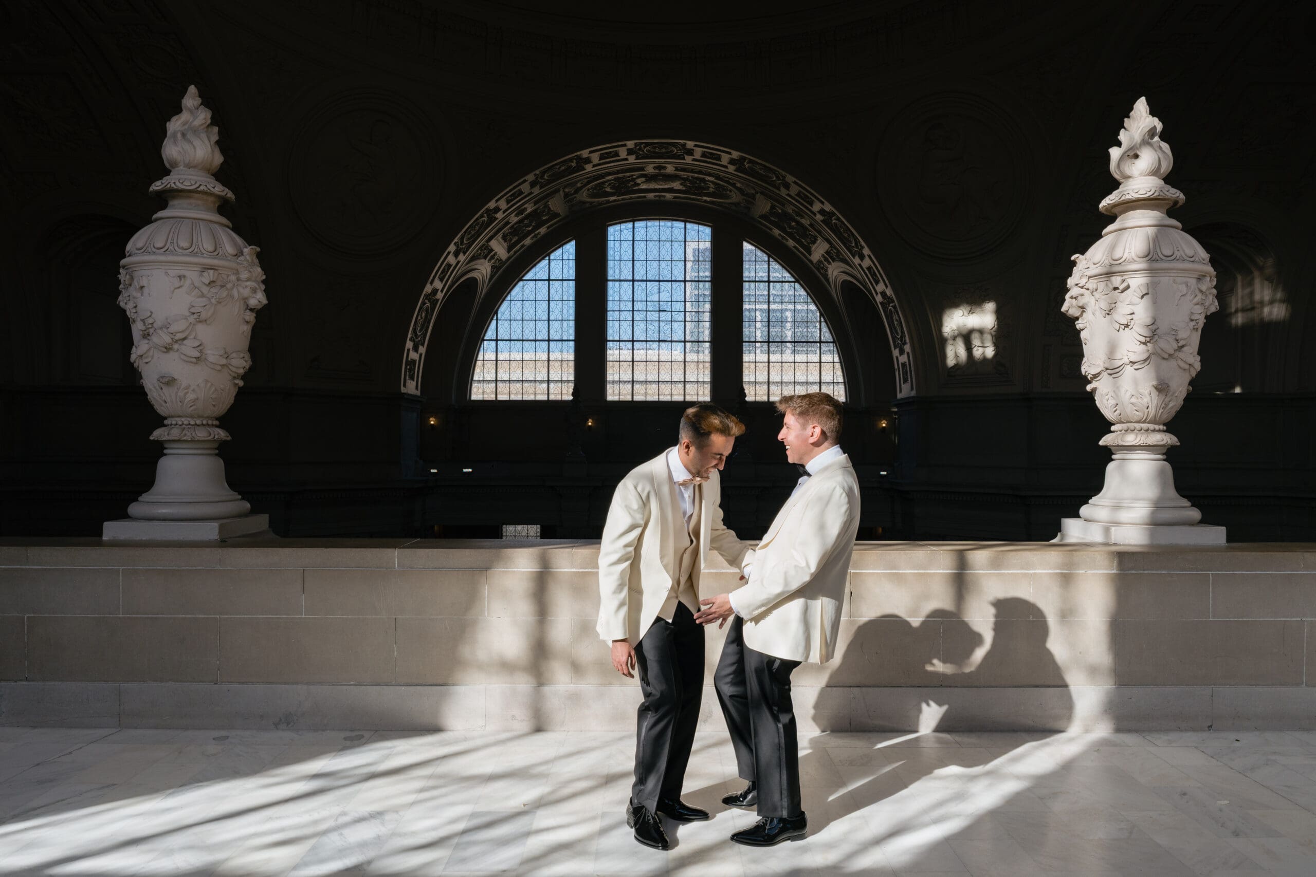 Newlyweds posing for elopement portraits in the soft natural light of the 4th Floor North Gallery at San Francisco City Hall.