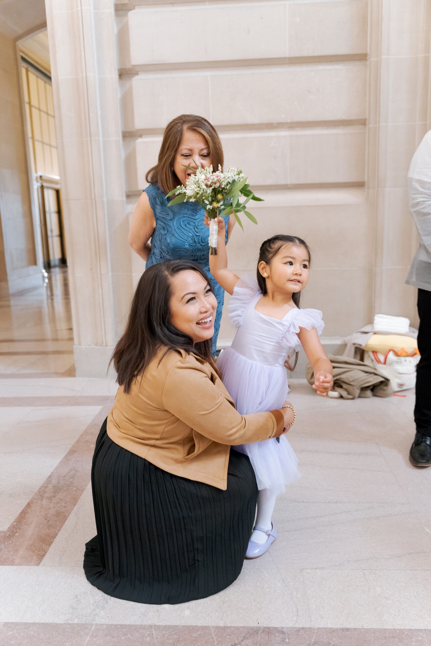 Candid photograph of family members in attendance of a San Francisco City Hall civil ceremony