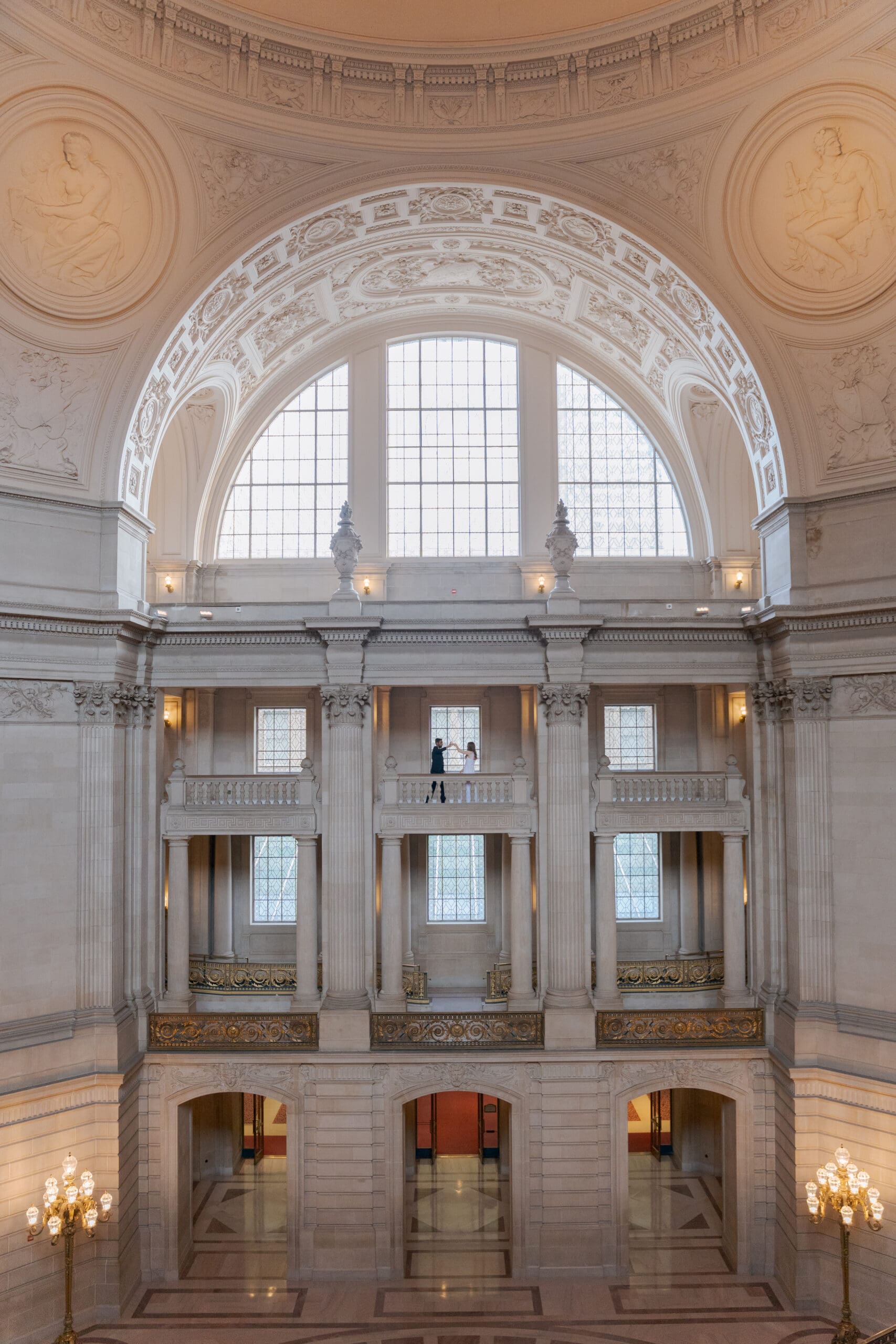 Wide interior shot showing the grand architecture and floors of San Francisco City Hall.
