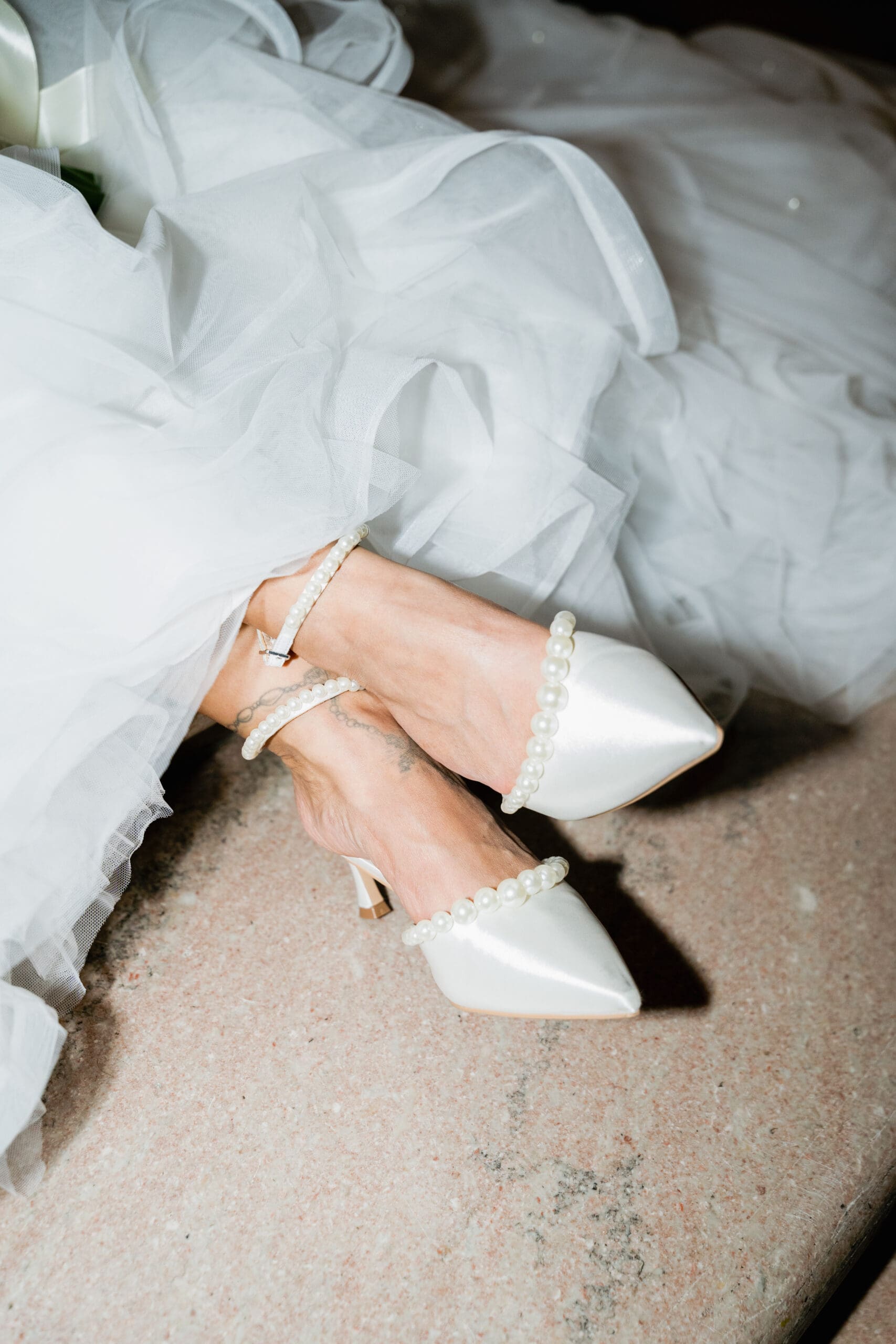 A bride's shoe details on the steps of the Grand Staircase in San Francisco City Hall