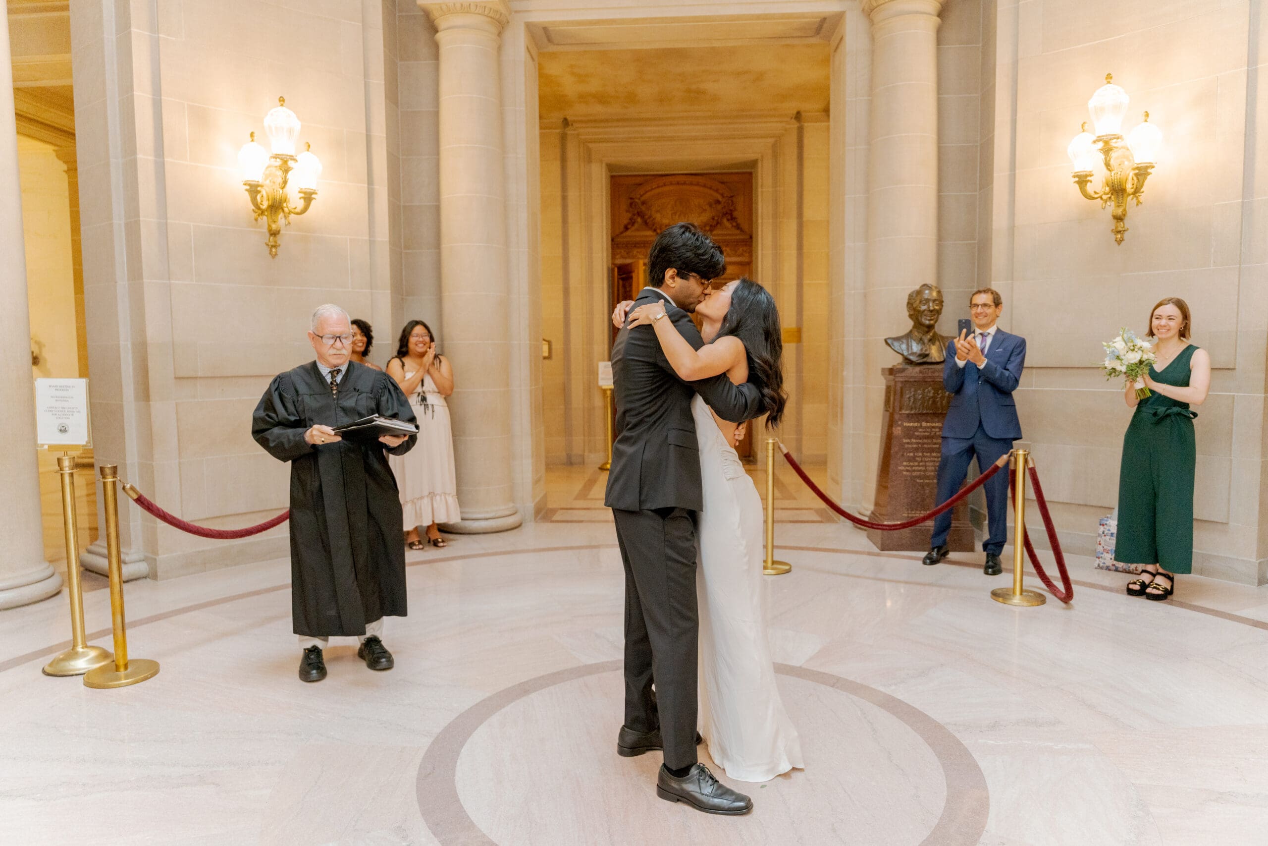 Newlyweds exchange a first kiss after the San Francisco County Clerk pronounces them officially married