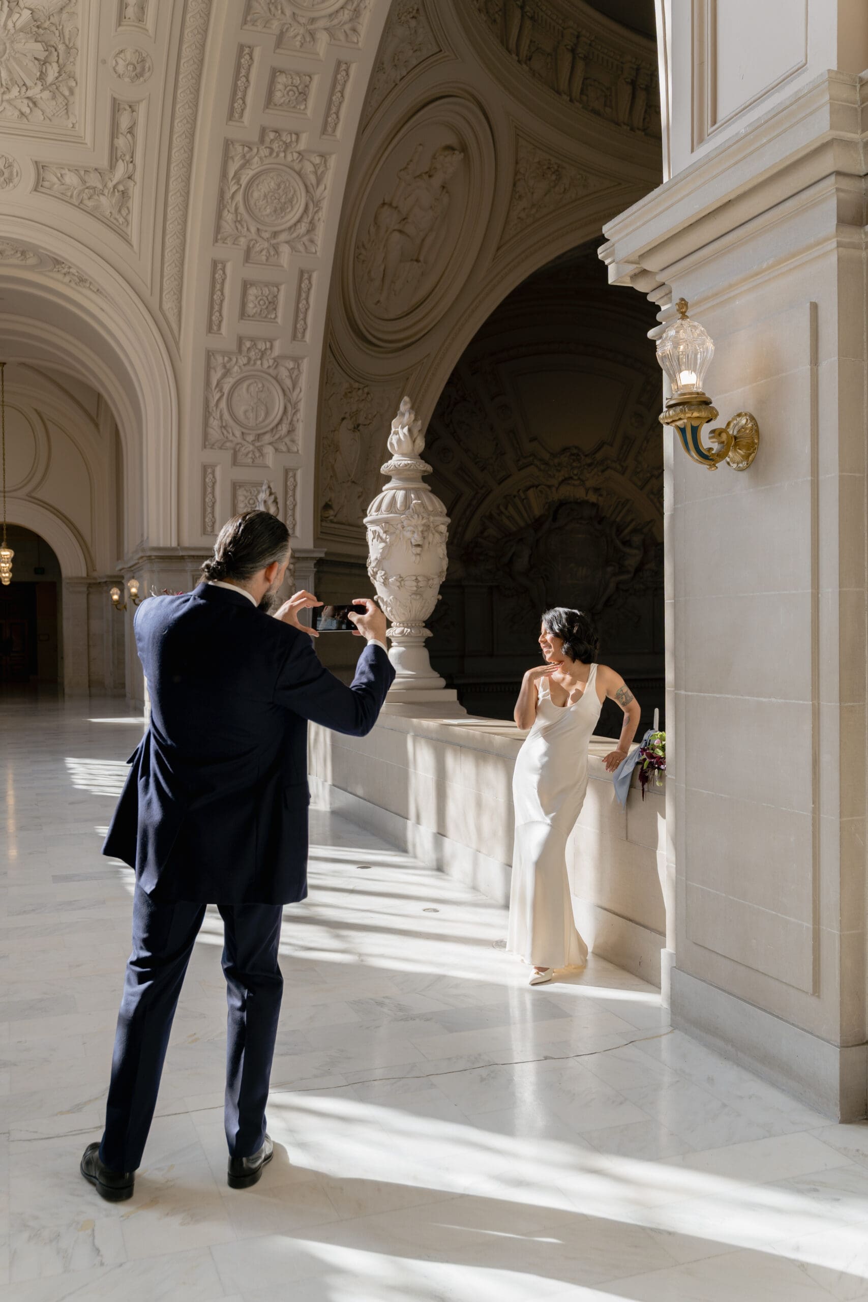 Candid moment of a wedding couple on the 4th floor gallery of San Francisco City Hall