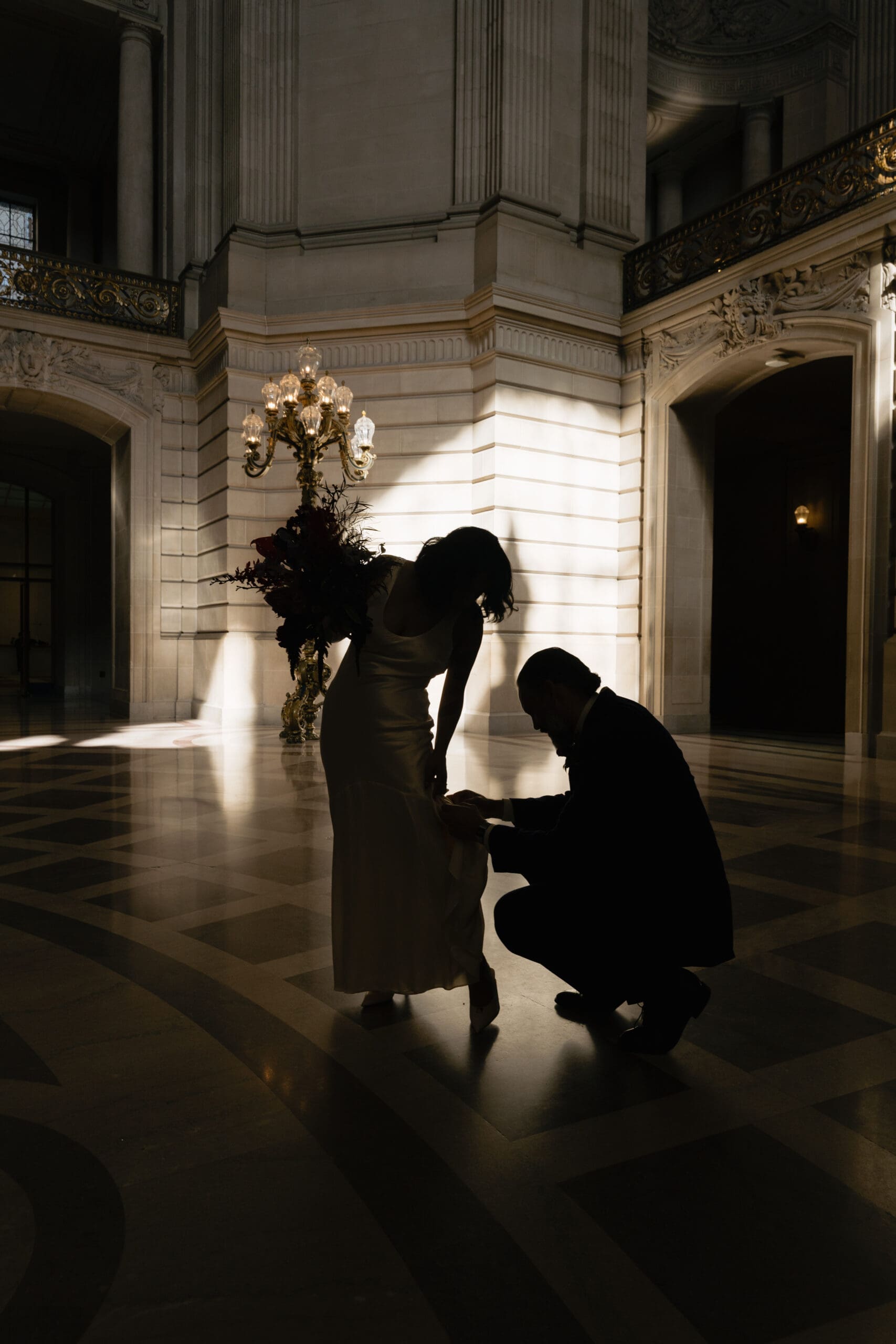 Bride and groom sharing a private moment on the first floor of SF City Hall.