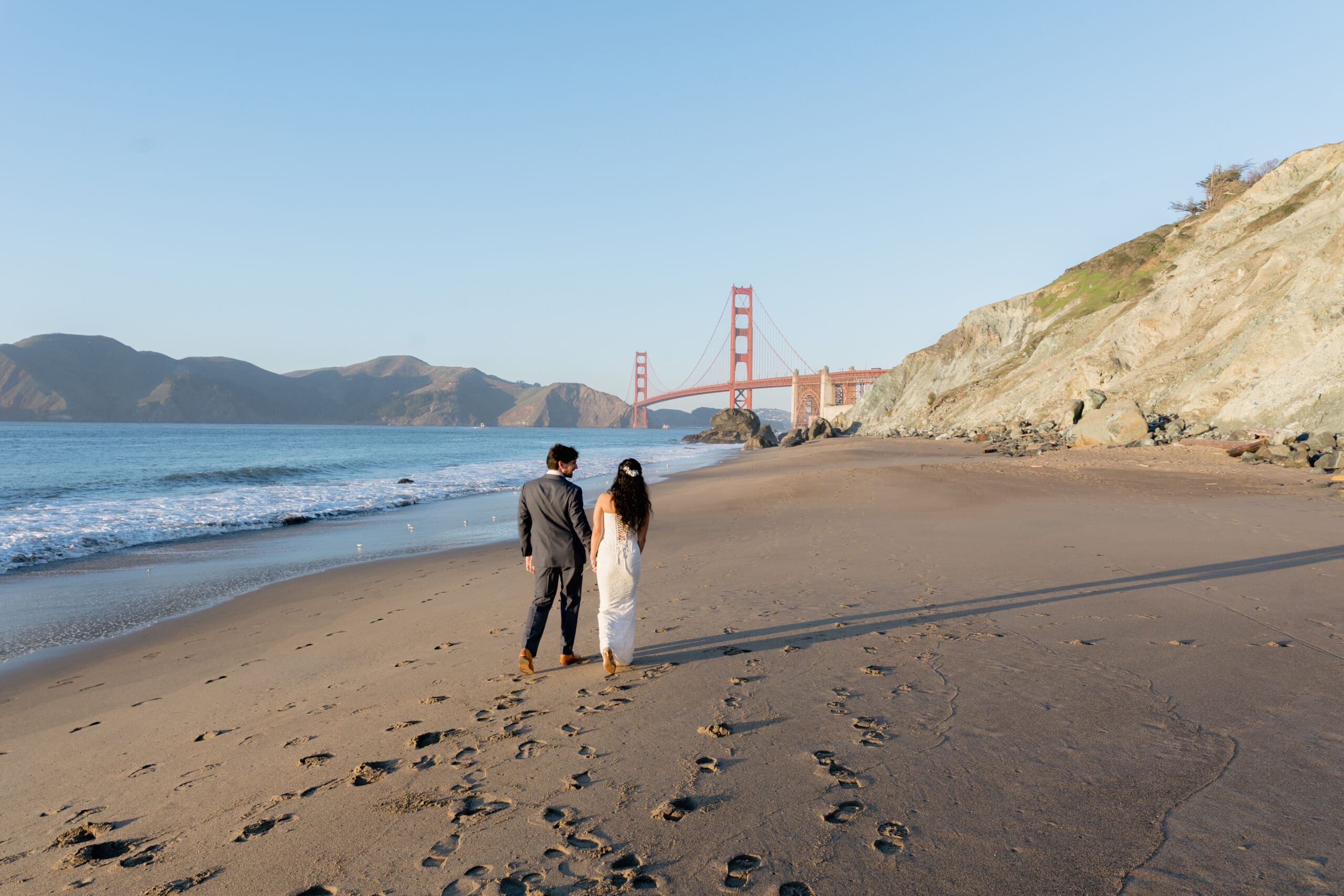 Newlyweds after their elopement on Marshall's Beach with the Golden Gate Bridge as a backdrop