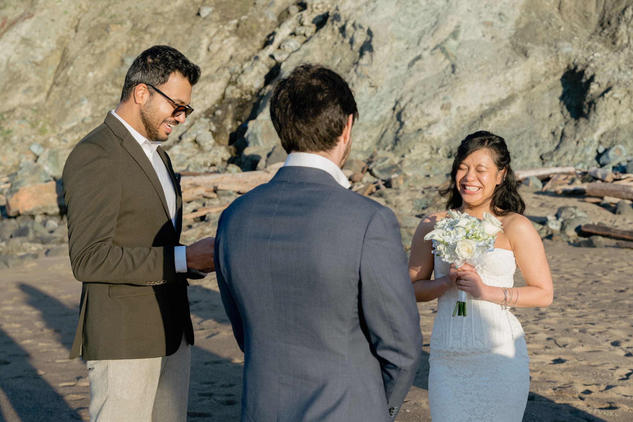 Bride and Groom laugh during their wedding ceremony on Marshall's Beach