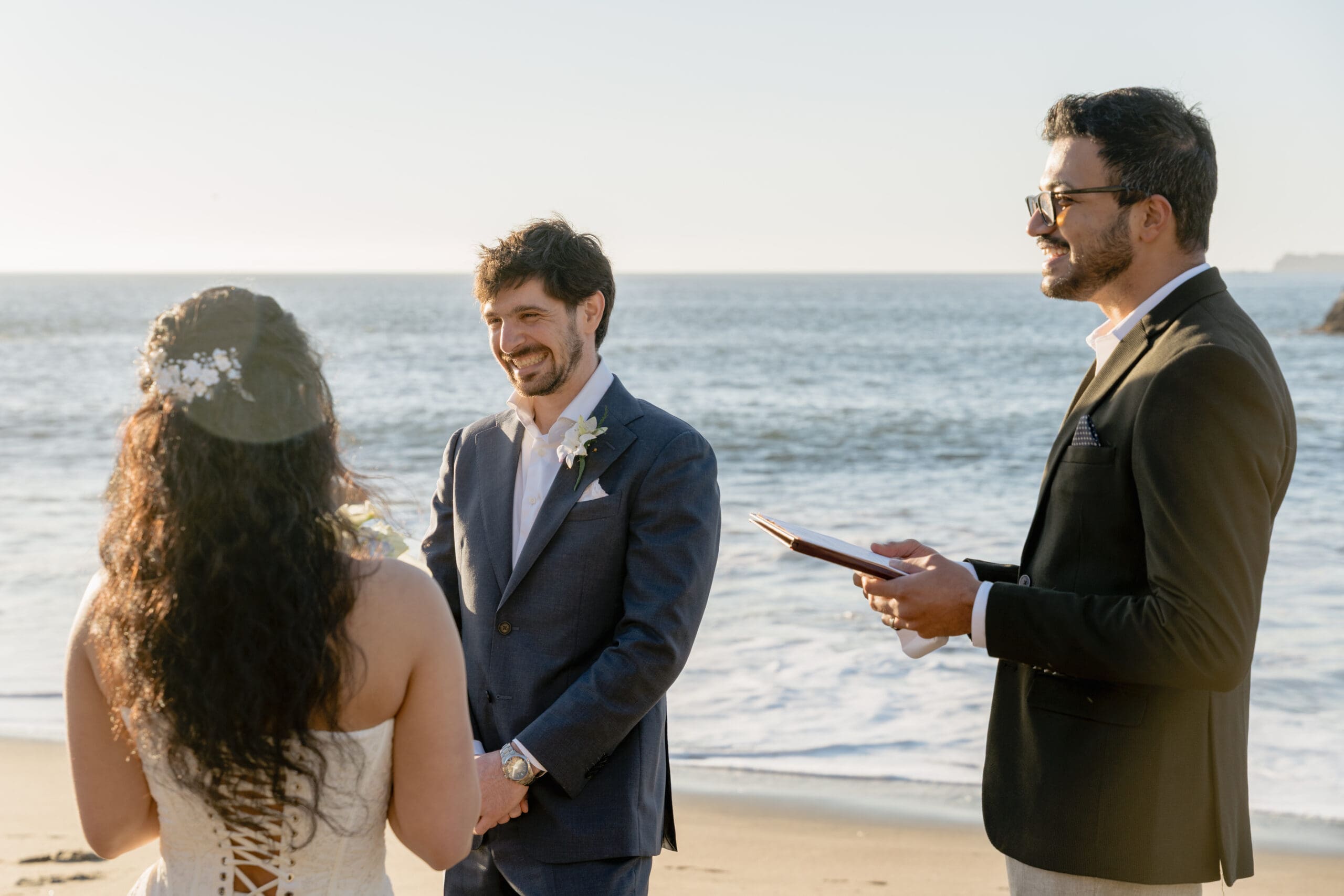 Laughter during an intimate elopement on Marshall's Beach in San Francisco