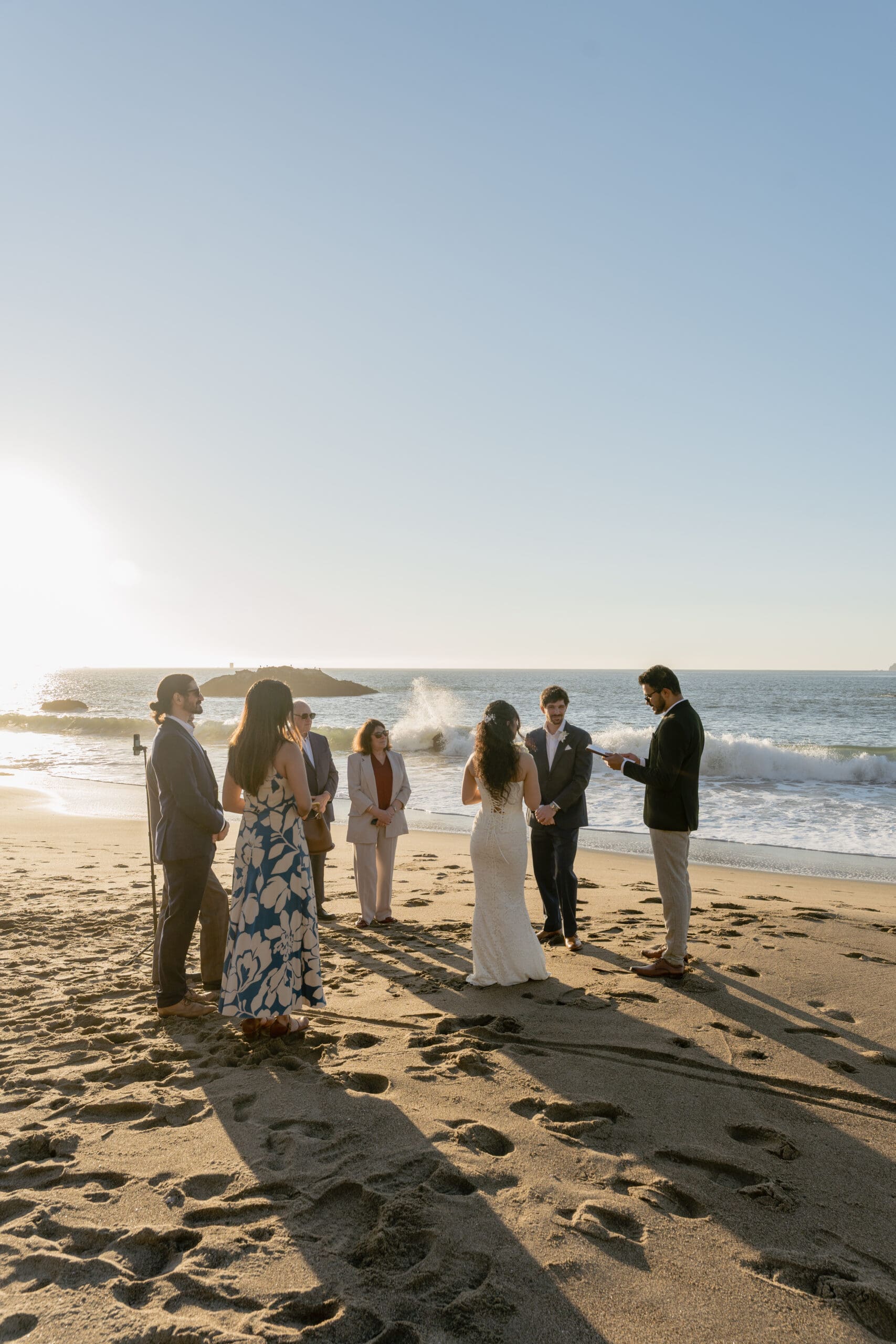 Waves crash on the shore at golden hour at Marshall's beaching during the couple's elopement