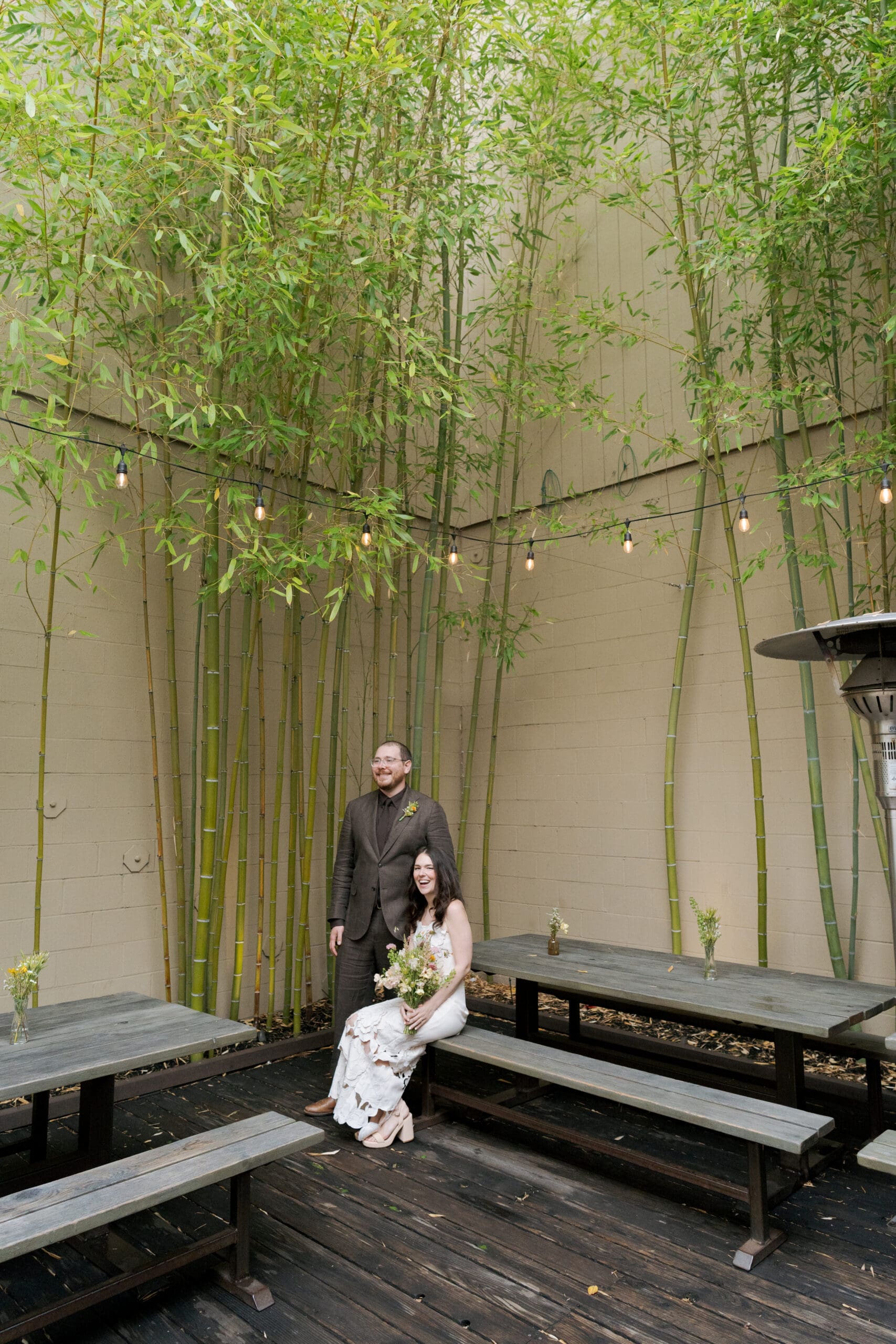 A modern bride and groom posing for portraits at their East Bay restaurant wedding.