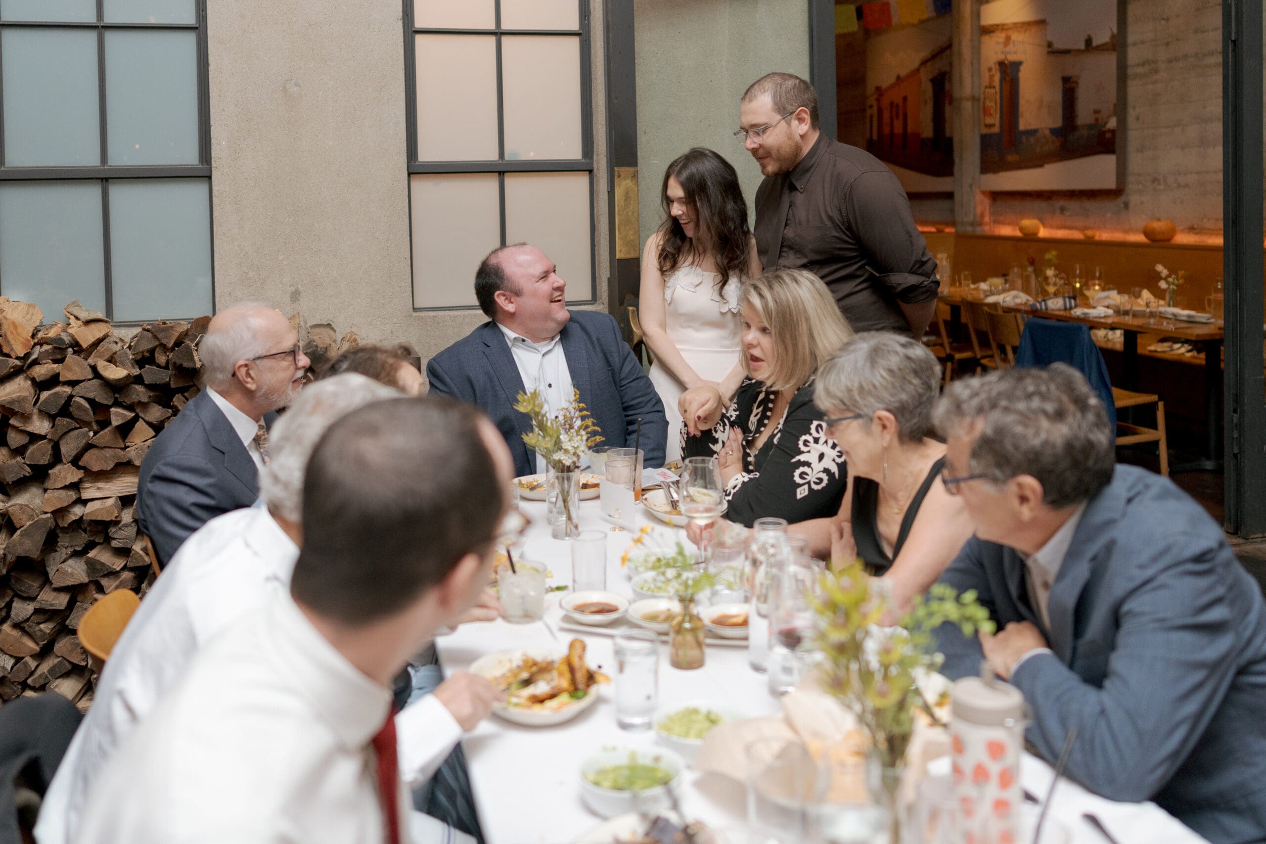 The couple sharing a quiet moment with guests after their Comal Berkeley wedding ceremony.