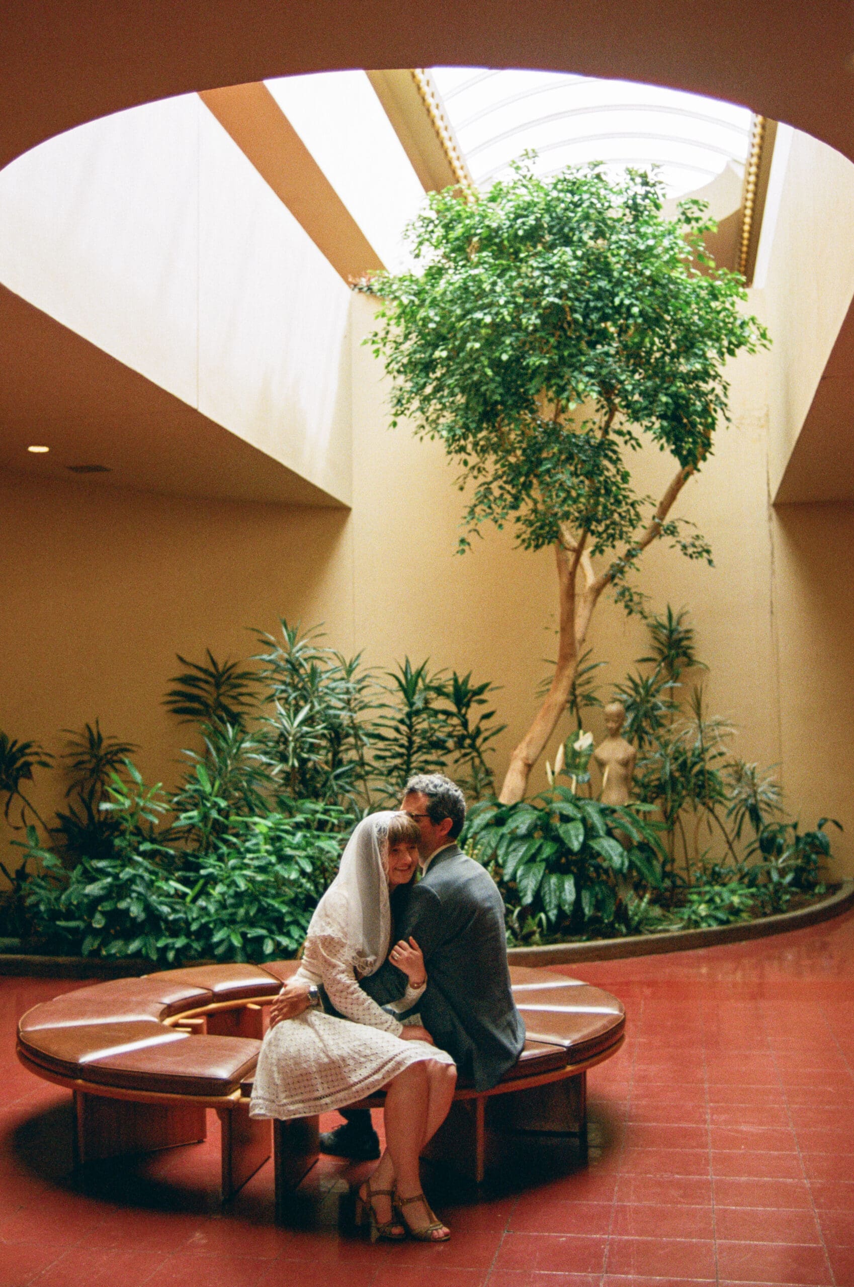 Moody newlywed portrait on film inside Marin County Civic Center