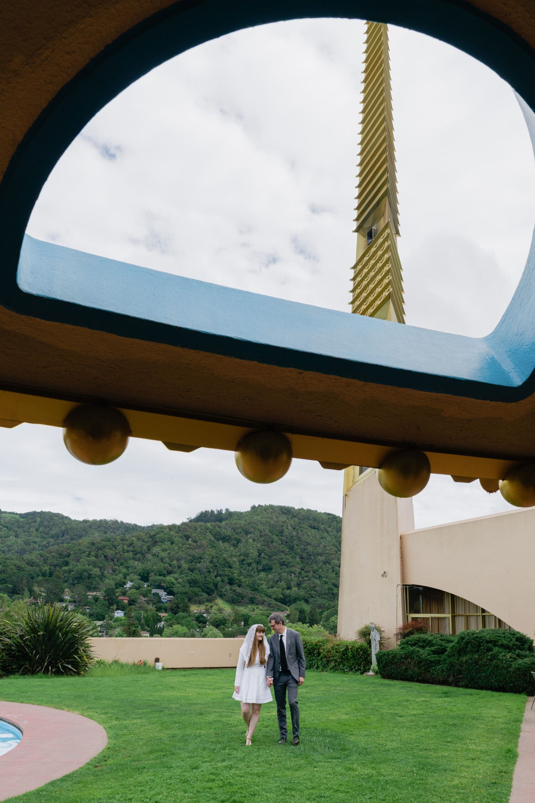 Architectural portrait of wedding couple in by the pool at Marin County Civic Center