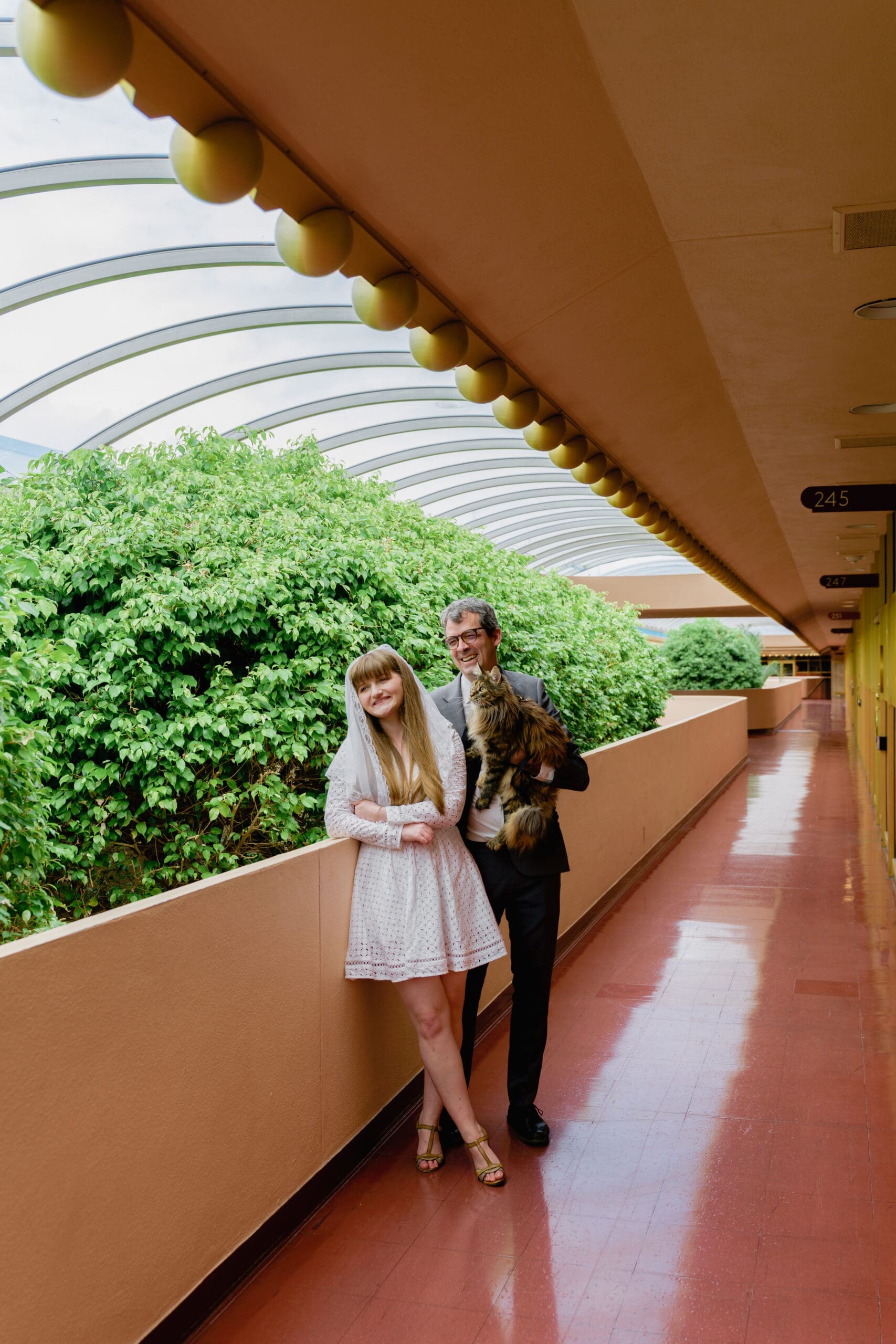 Wedding portrait in the iconic hallways of Marin County Civic Center with golden accents
