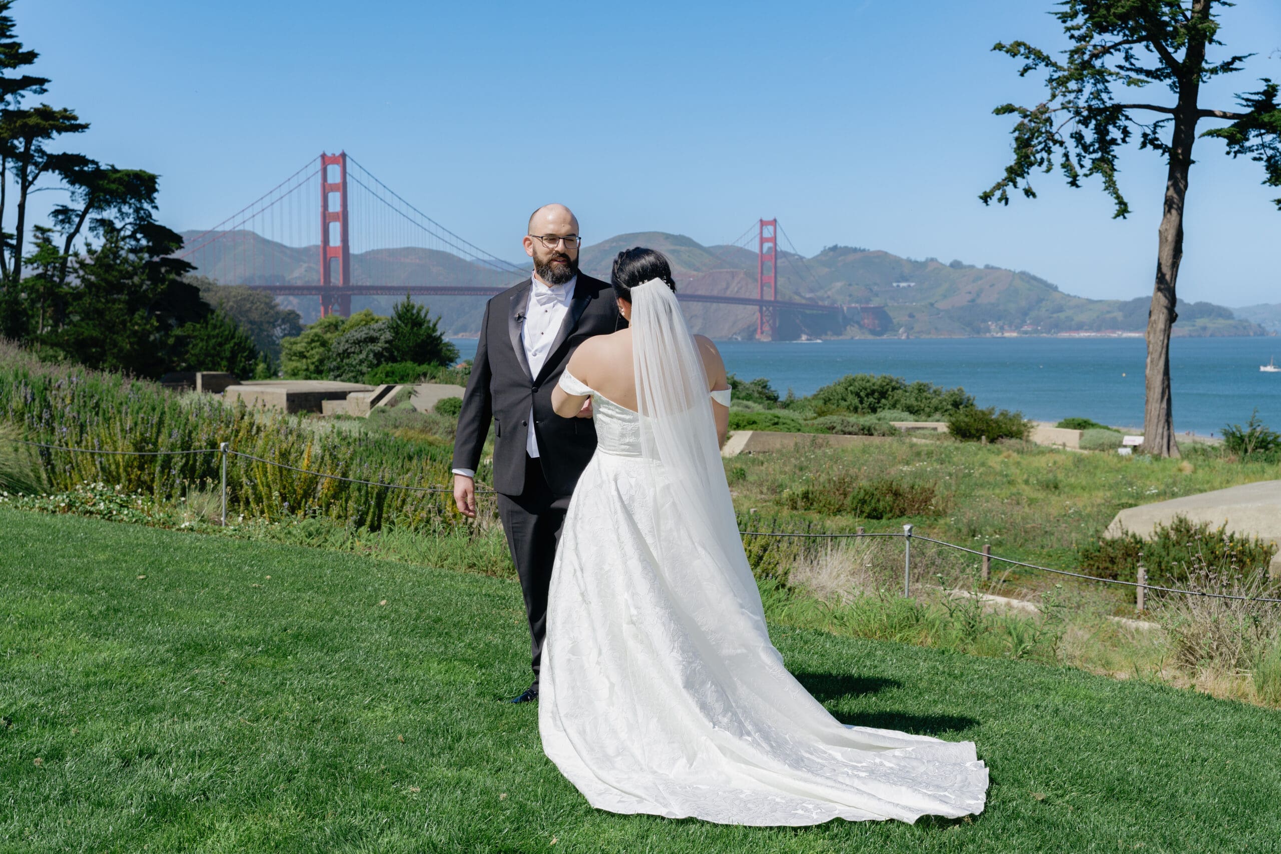 Groom sees bride for the first time during the first look at Battery Bluff Park