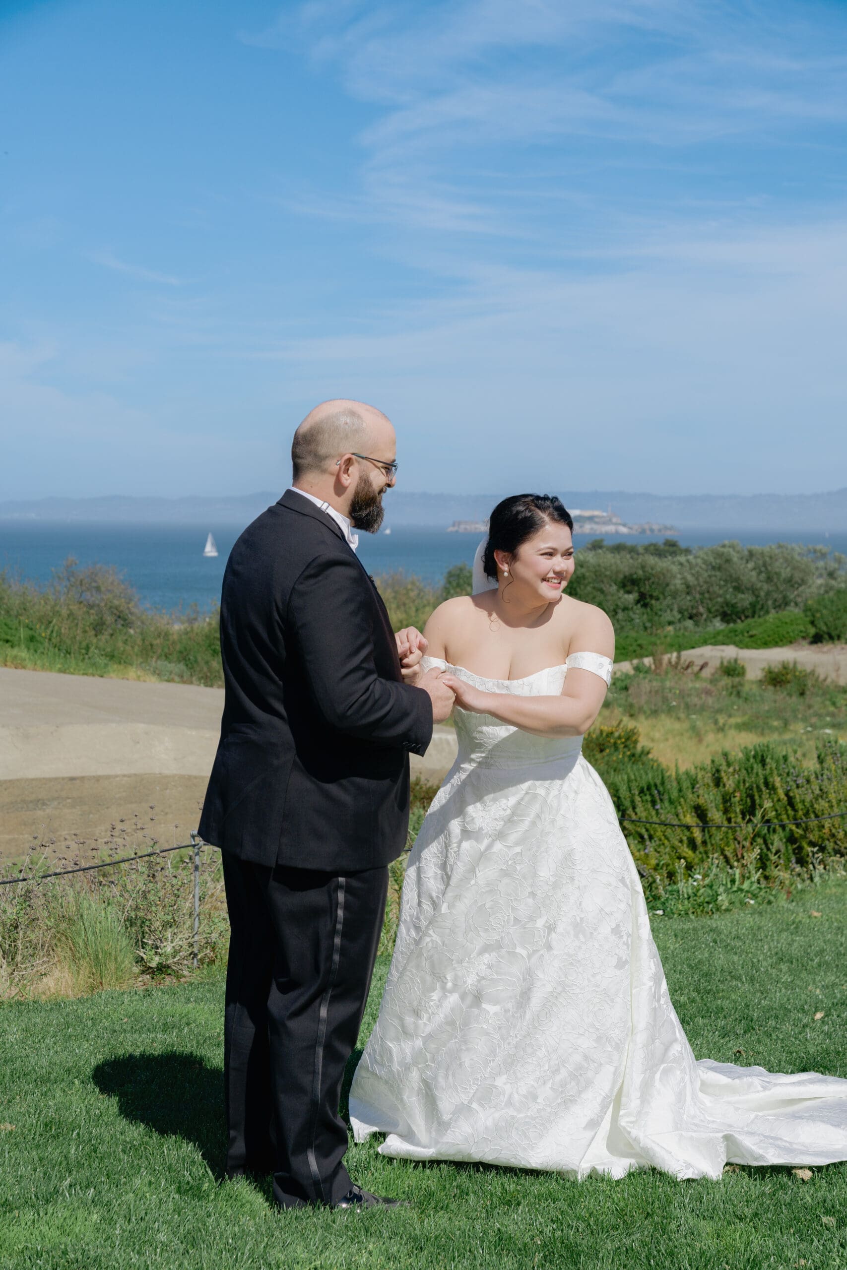 Happy bride and groom during their first look on the San Francisco coast