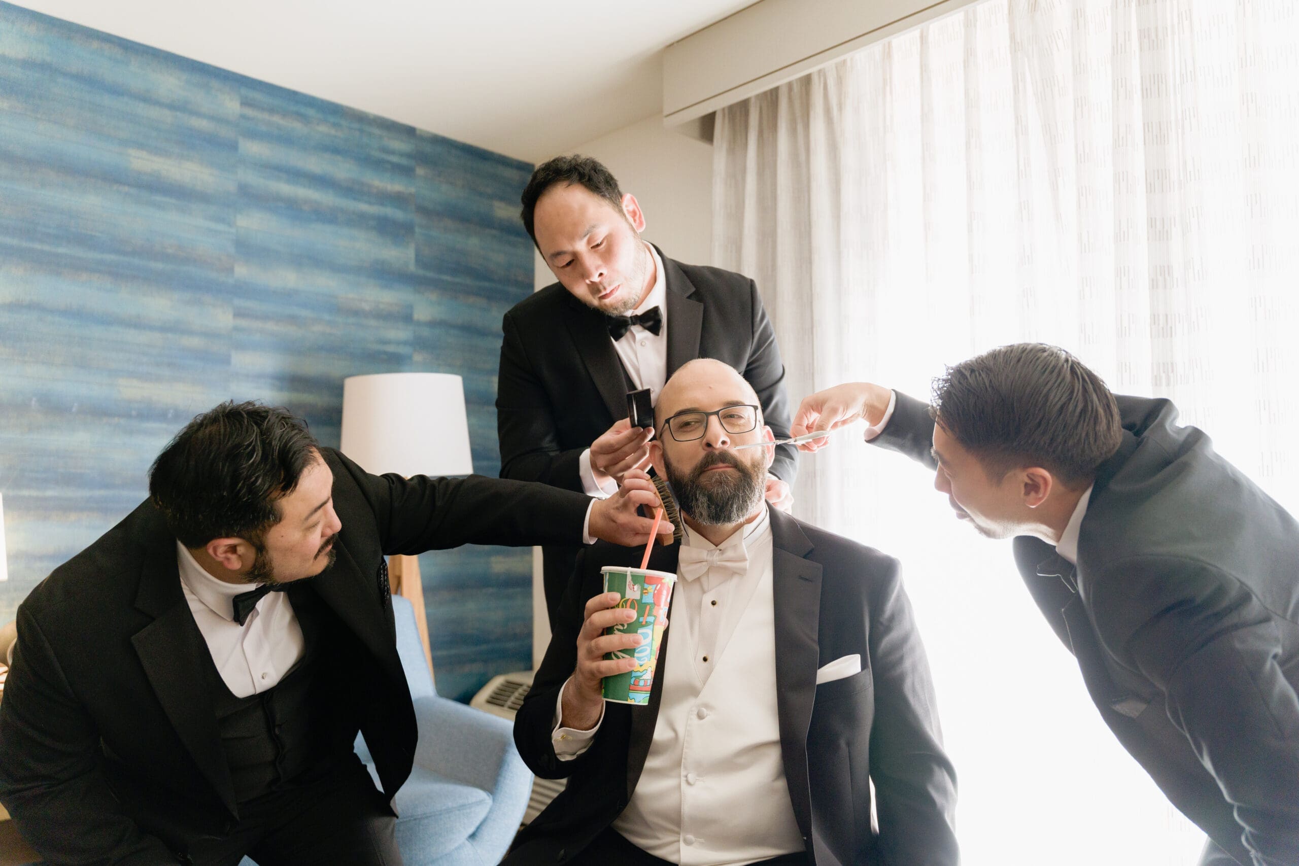 Groomsmen taking a silly getting ready photo with the groom