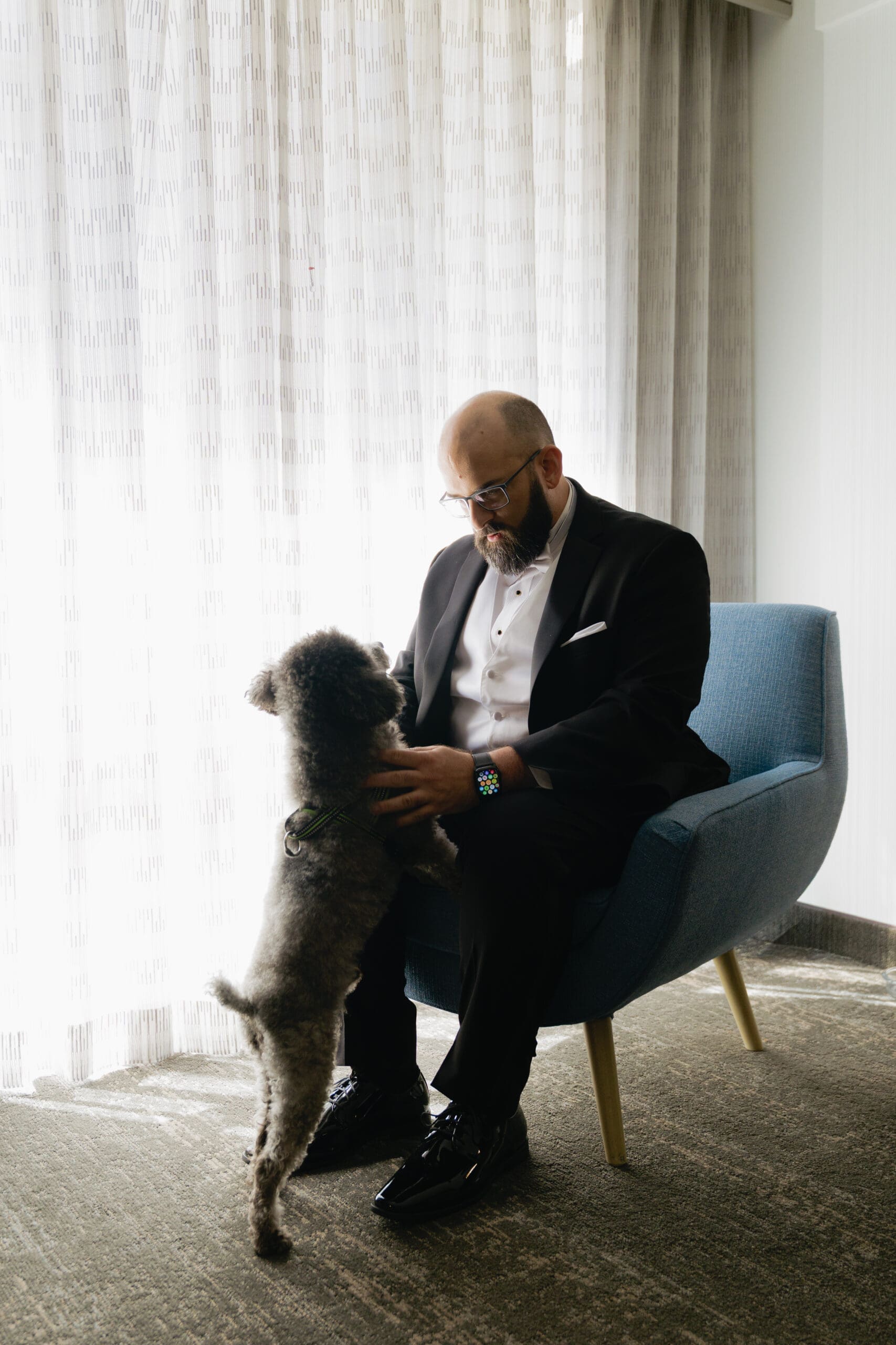 Groom and their dog, their ring bearer, at their hotel