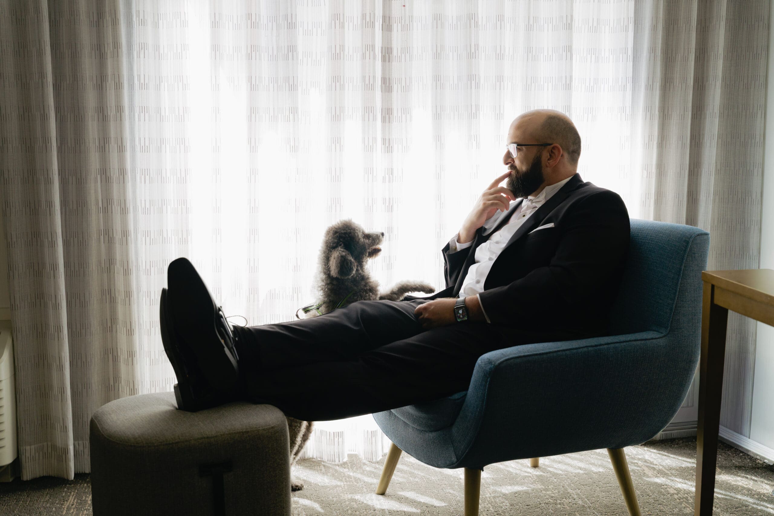Groom's getting ready photos with dog at their hotel room
