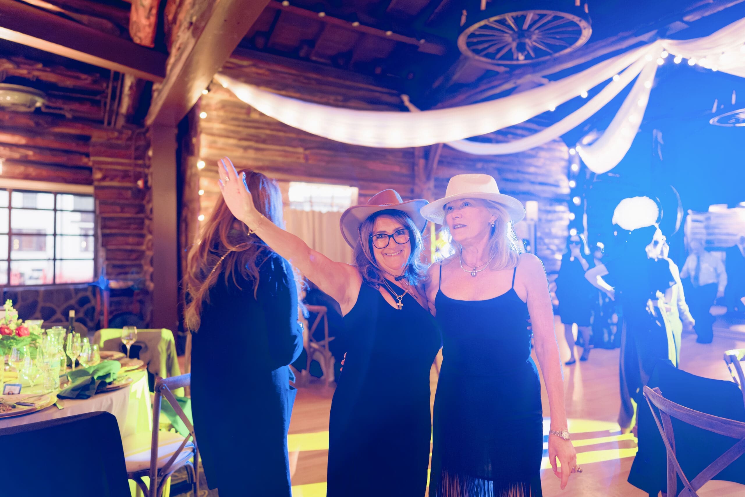 Fun hats and props during dance floor reception at the Wedgewood Log Cabin
