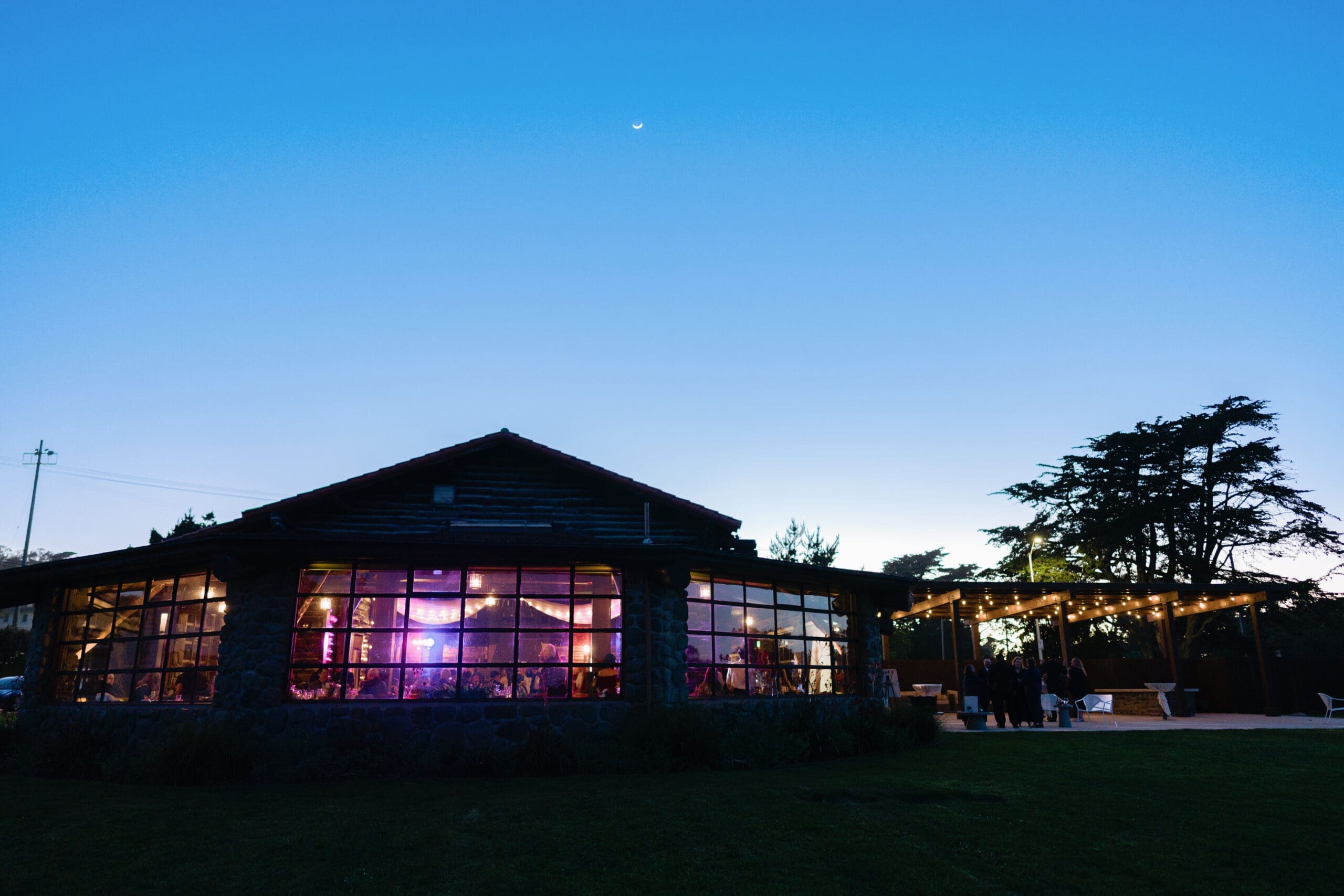 Dusk exterior shot outside of the Presidio Log Cabin