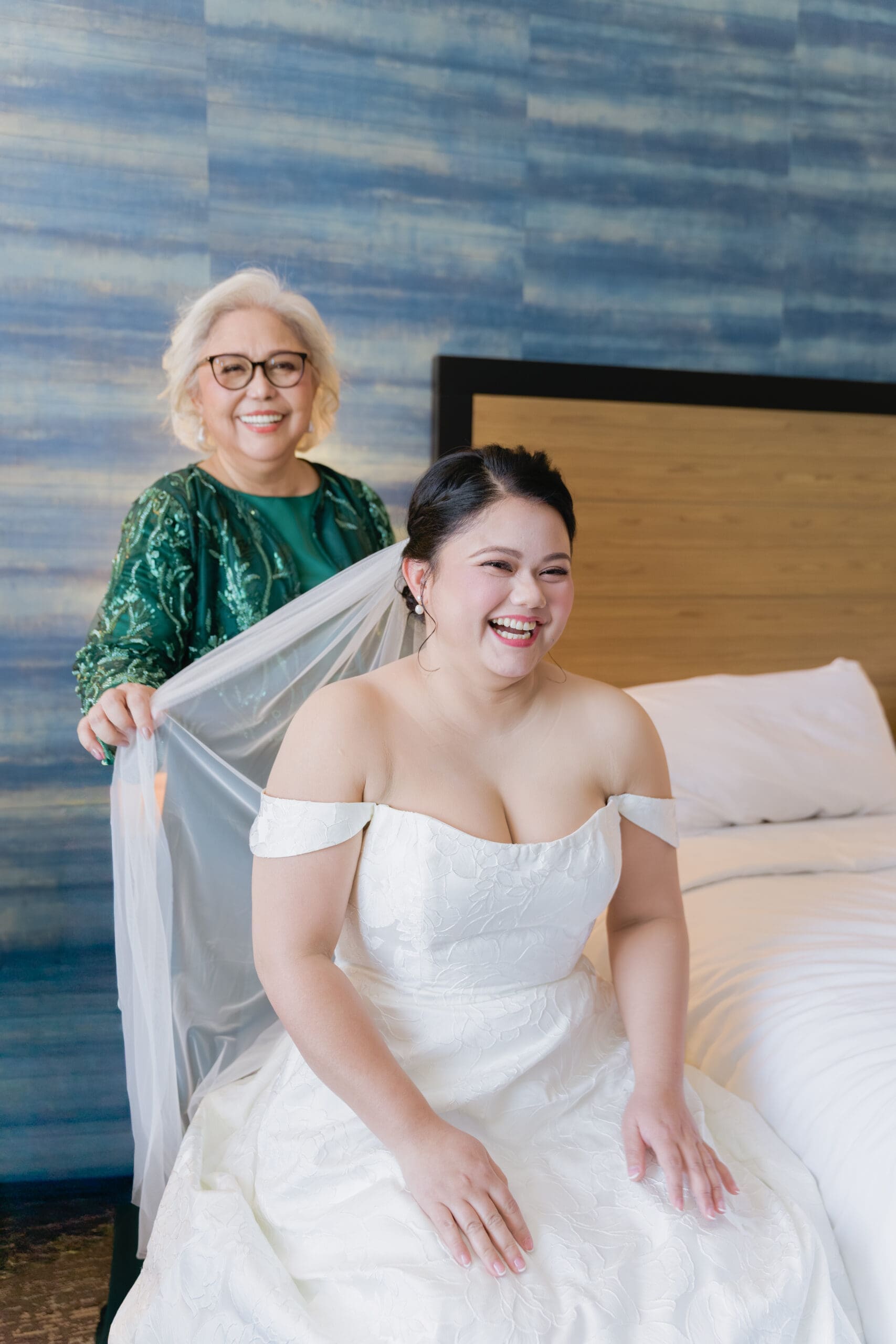 Smiling bride with her mother while getting ready at their San Francisco Hotel