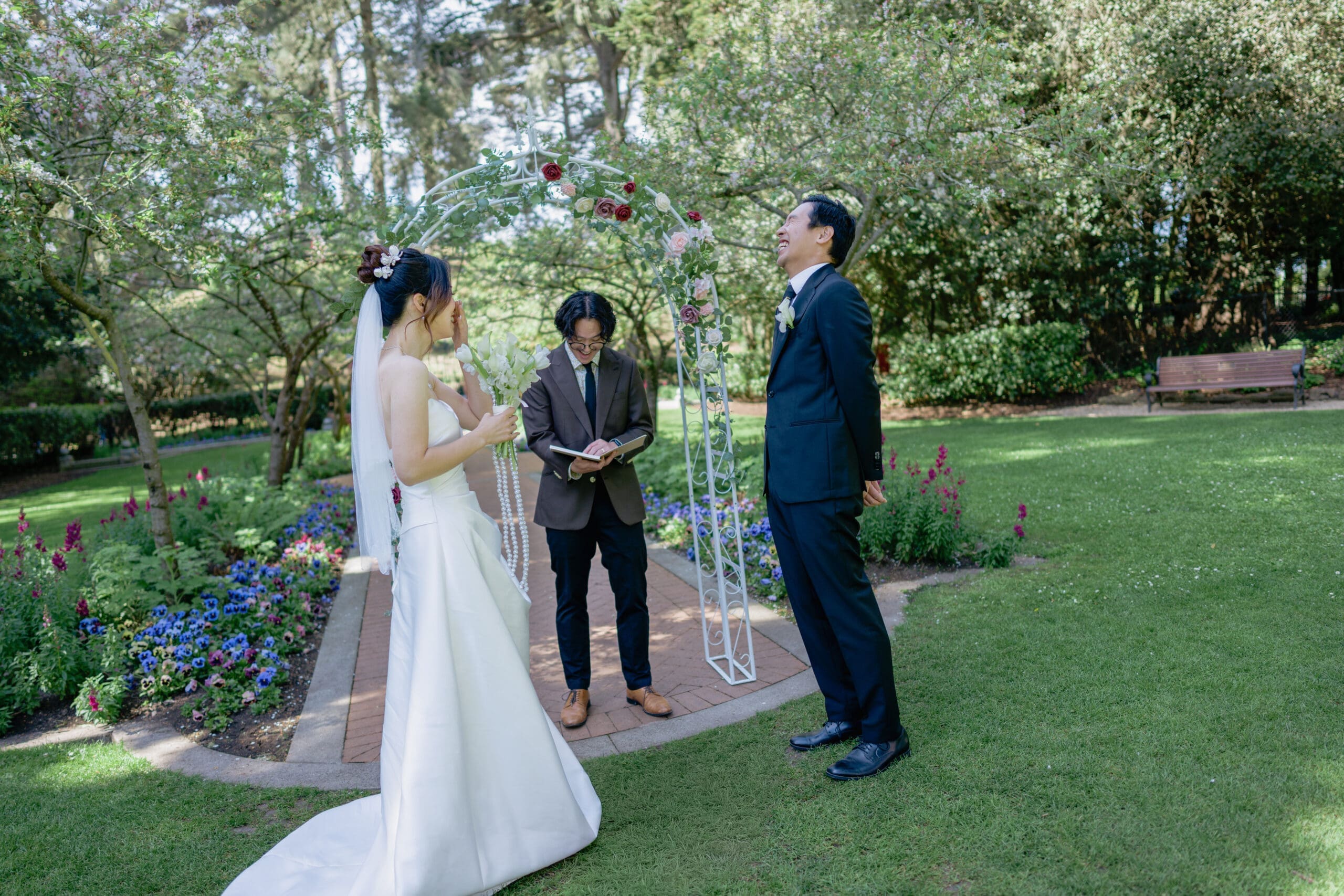 Bride and groom exchanging laughter and vows during a private ceremony in Golden Gate Park's Shakespeare Garden
