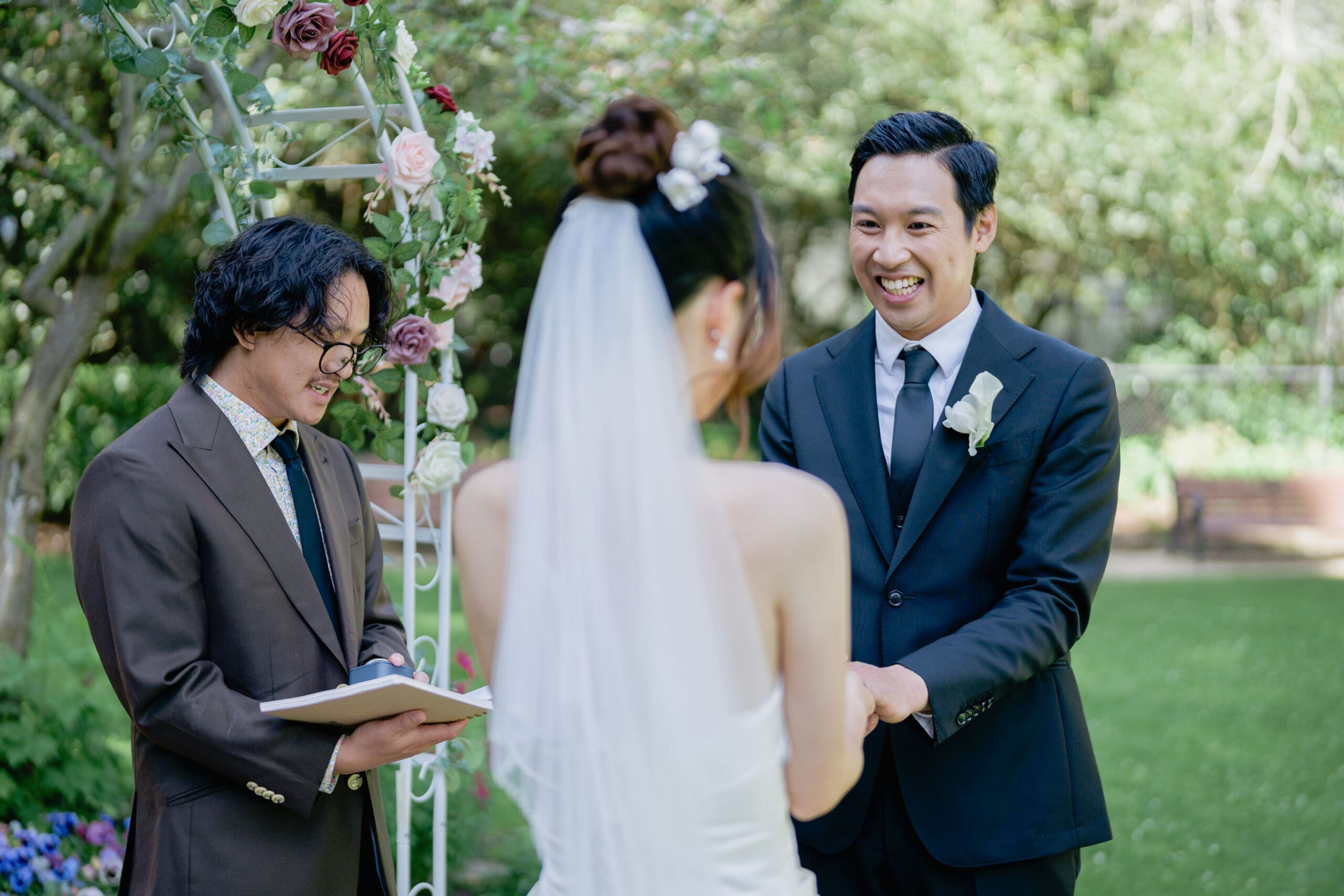Excited groom during the outdoor ceremony in the San Francisco Golden Gate Park Shakespeare Garden