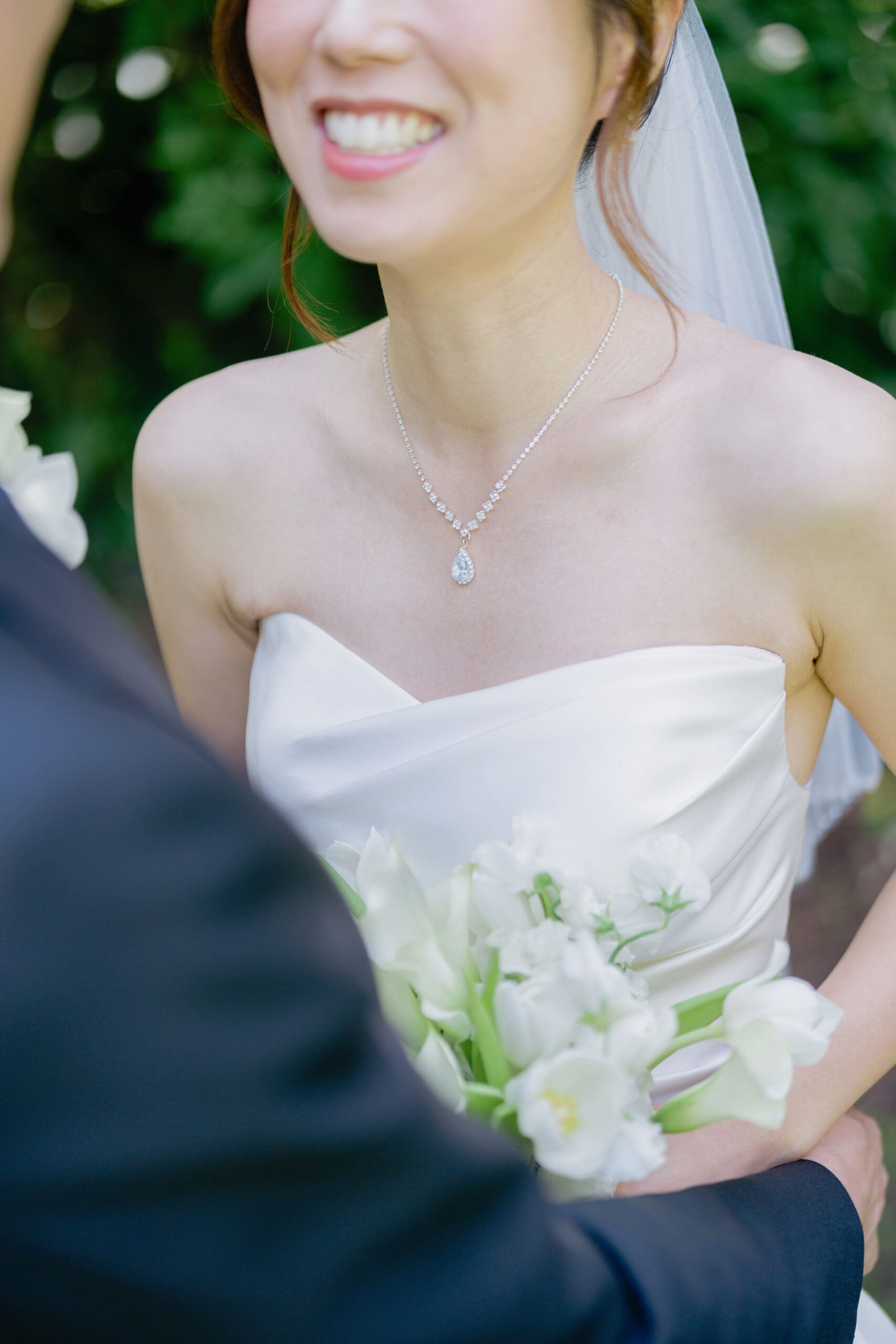 Bridal details with necklace and bouquet