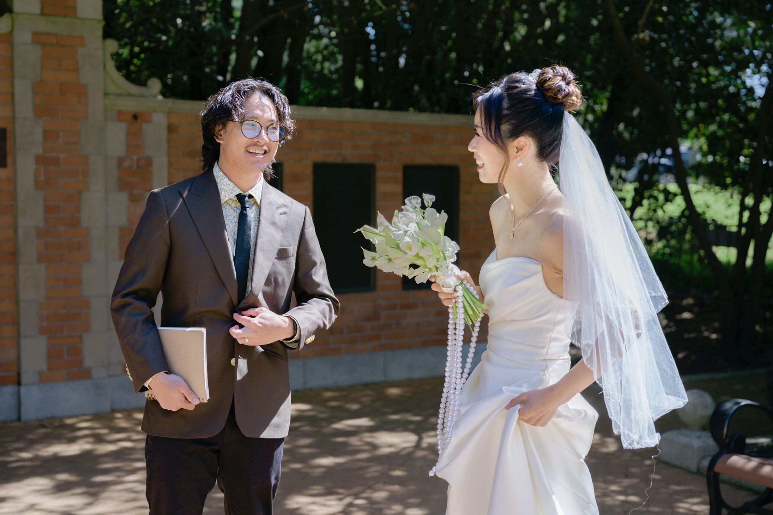 Bride and her friend and wedding officiant share a laugh before the big moment in the Shakespeare Garden