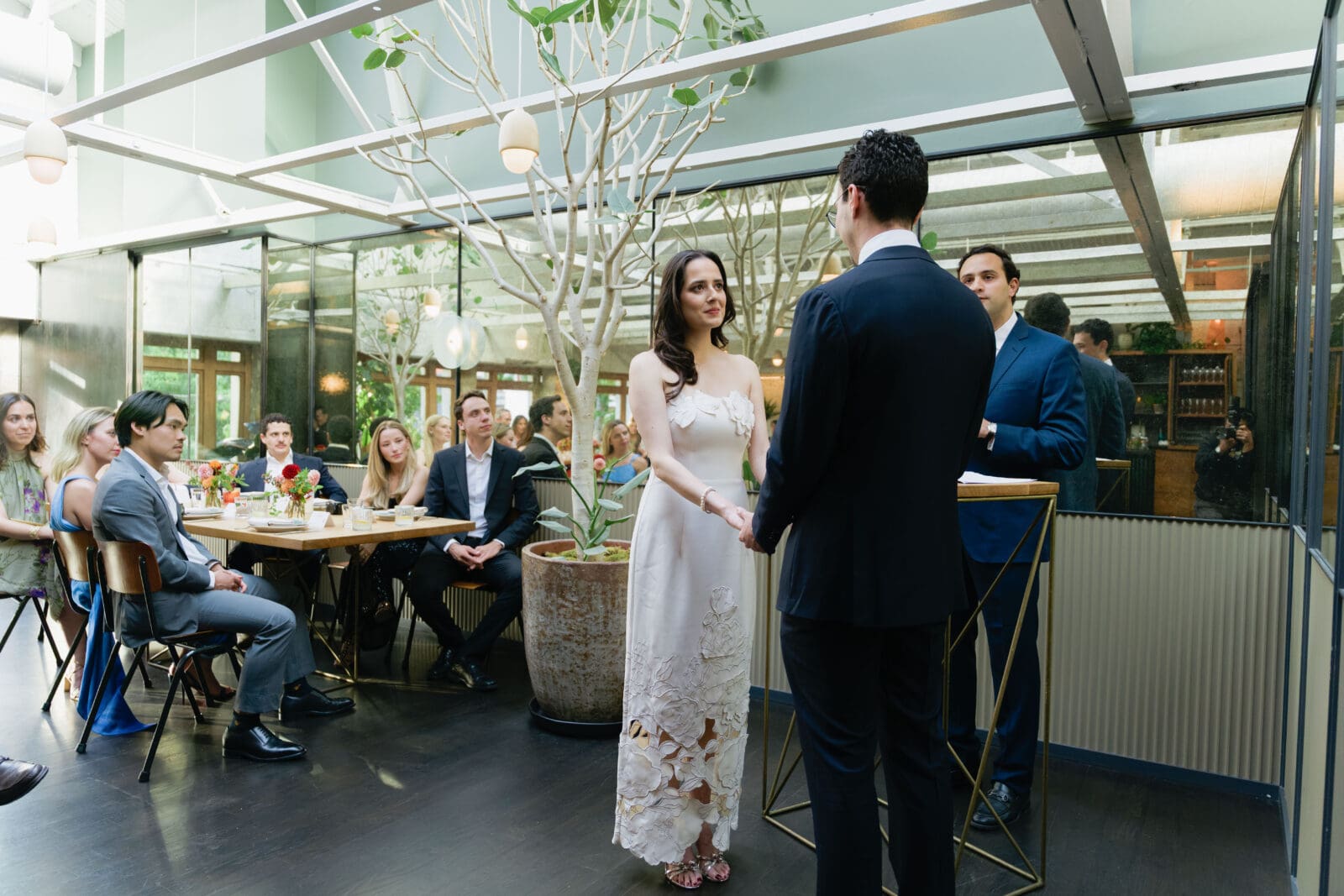 Bride and groom exchanging vows in front of custom mirror walls during a micro wedding at The Progress SF