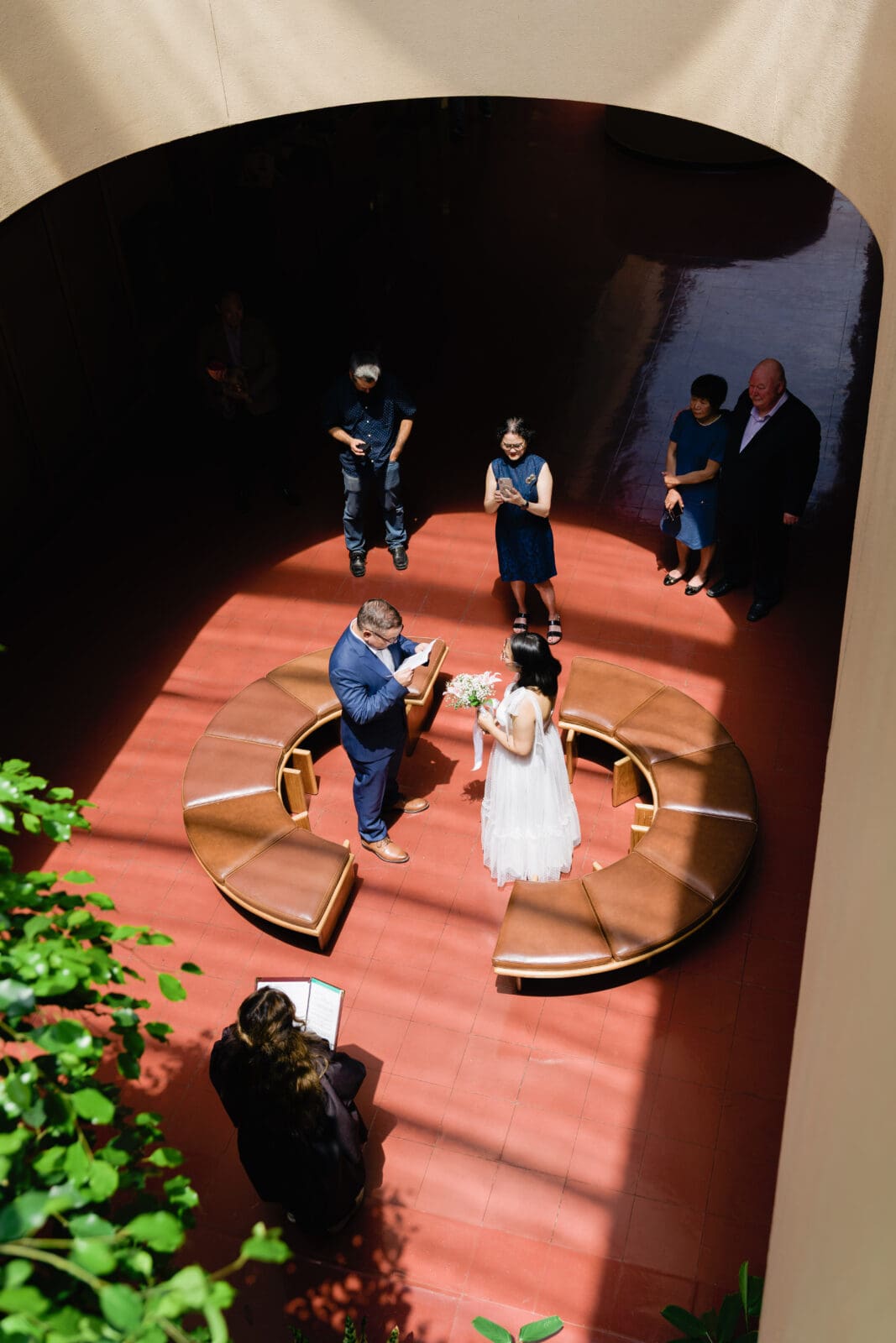 Groom reading his vows, surrounded by family, during civil ceremony elopement at Marin County Civic Center