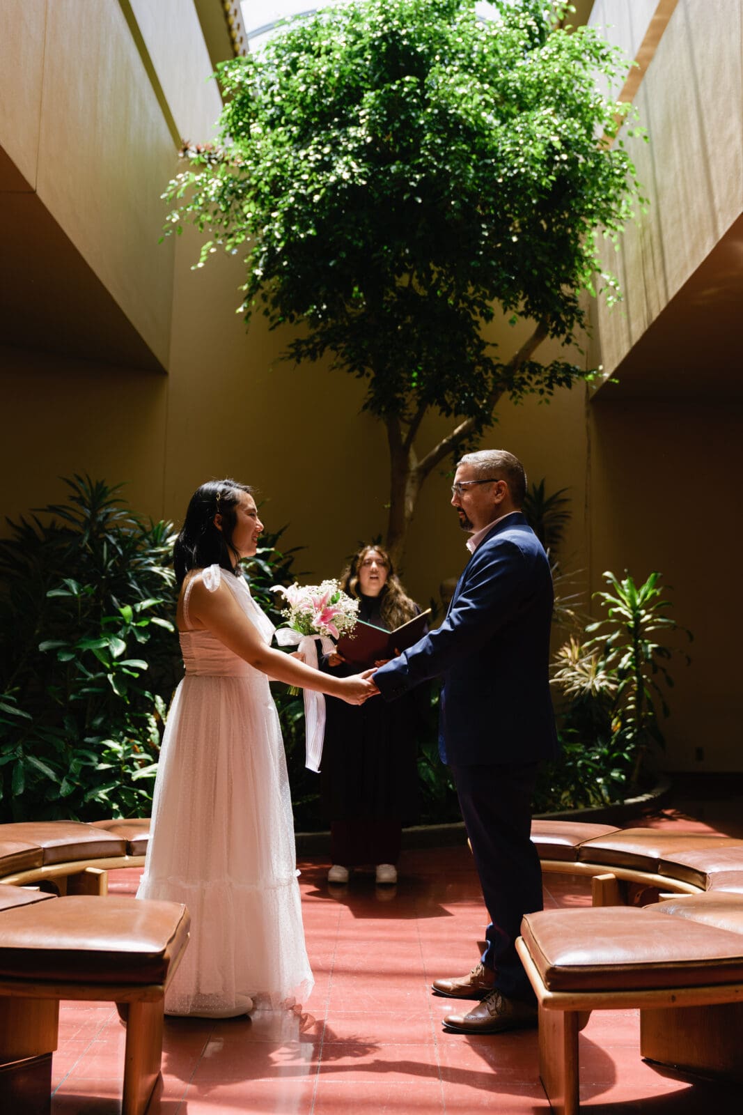 Bride and groom exchanging vows during a civil ceremony at Marin County Civic Center
